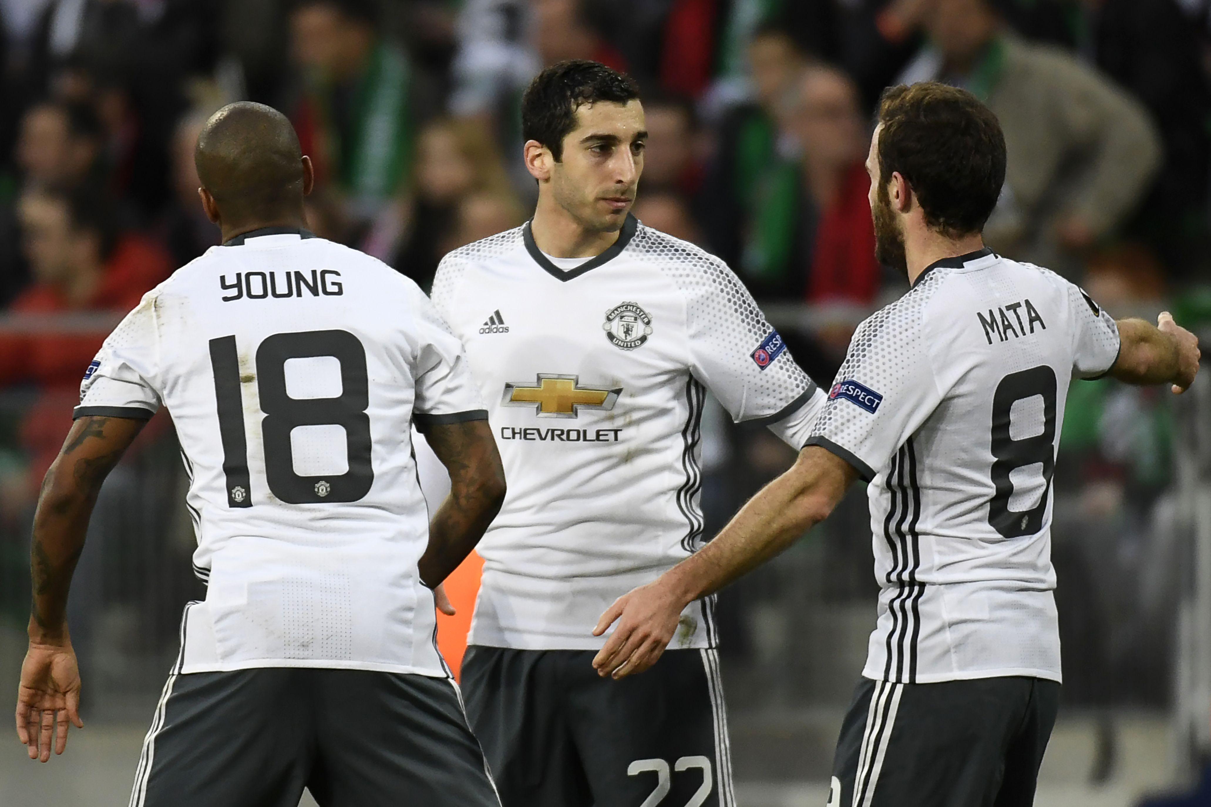 Manchester's United's Armenian forward Henrikh Mkhitaryan (C) celebrates with teammates Spanish midfielder Juan Mata (R) and British midfielder Ashley Young (L) after scoring a goal during the UEFA Europa League football match between AS Saint-Etienne and Manchester United on February 22, 2017, at the Geoffroy Guichard stadium in Saint-Etienne, central France. / AFP / PHILIPPE DESMAZES        (Photo credit should read PHILIPPE DESMAZES/AFP/Getty Images)