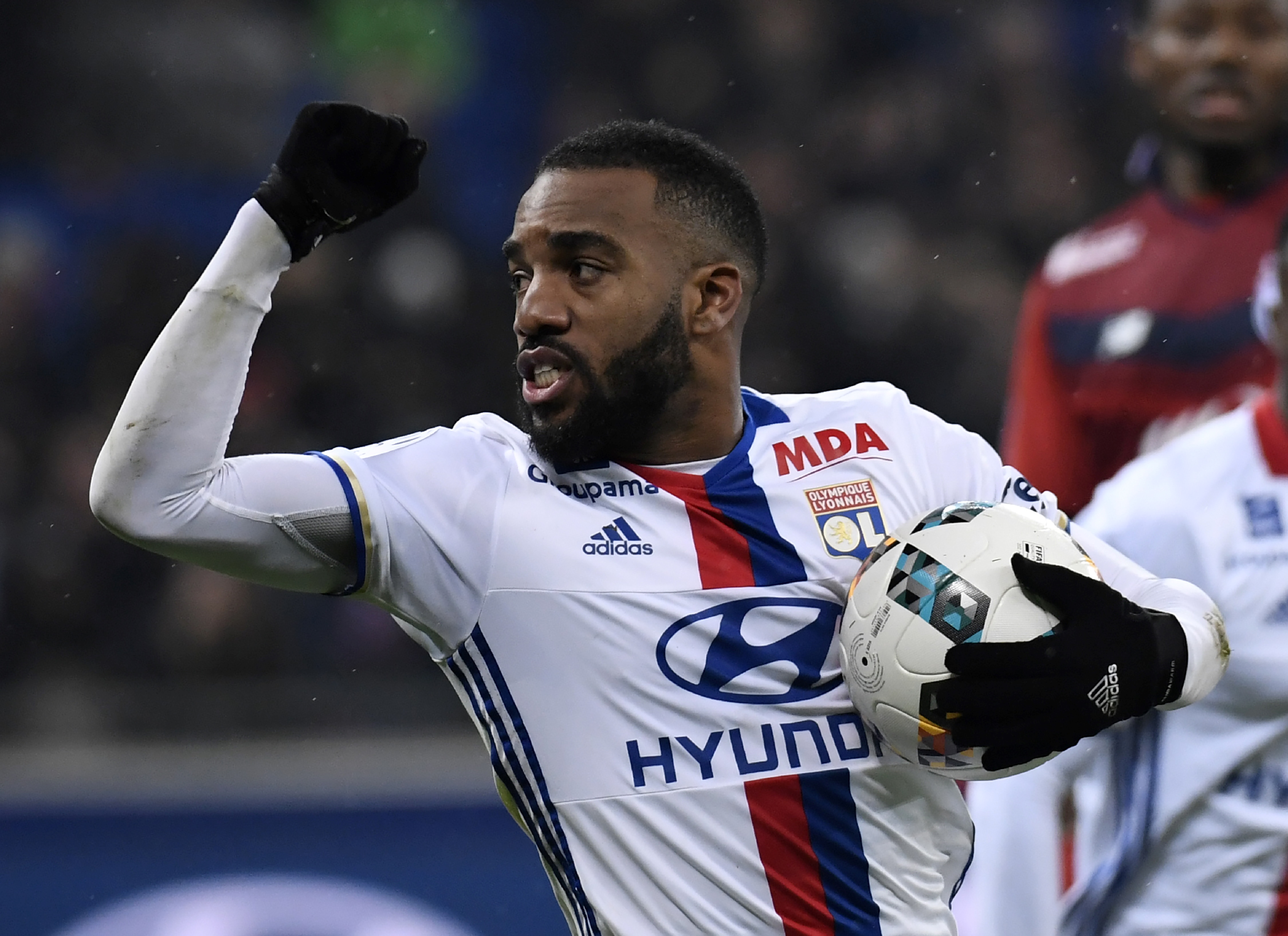 Lyon's French forward Alexandre Lacazette celebrates after scoring a penalty  during the French L1 football match Olympique Lyonnais (OL) against Lille (LOSC) on January 28, 2017, at the Parc Olympique Lyonnais stadium in Decines-Charpieu near Lyon, central-eastern France.    / AFP / PHILIPPE DESMAZES        (Photo credit should read PHILIPPE DESMAZES/AFP/Getty Images)