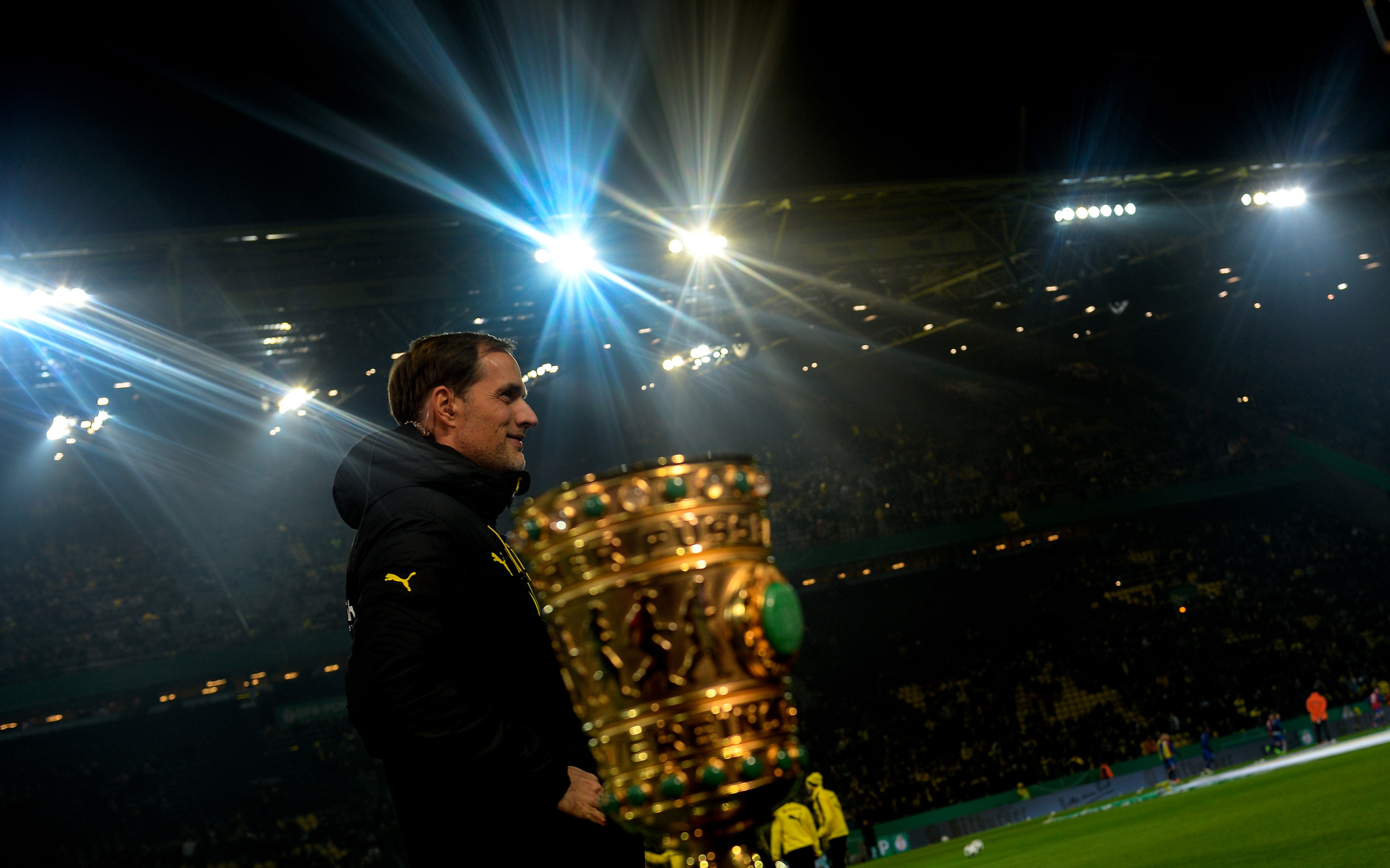 Dortmund's head coach Thomas Tuchel gives an interview next to the trophy prior to the German Cup DFB Pokal round of 16 football match BVB Borussia Dortmund v Hertha Berlin in Dortmund, western Germany on February 8, 2017. / AFP / SASCHA SCHUERMANN / RESTRICTIONS: ACCORDING TO DFB RULES IMAGE SEQUENCES TO SIMULATE VIDEO IS NOT ALLOWED DURING MATCH TIME. MOBILE (MMS) USE IS NOT ALLOWED DURING AND FOR FURTHER TWO HOURS AFTER THE MATCH. == RESTRICTED TO EDITORIAL USE == FOR MORE INFORMATION CONTACT DFB DIRECTLY AT +49 69 67880

 /         (Photo credit should read SASCHA SCHUERMANN/AFP/Getty Images)