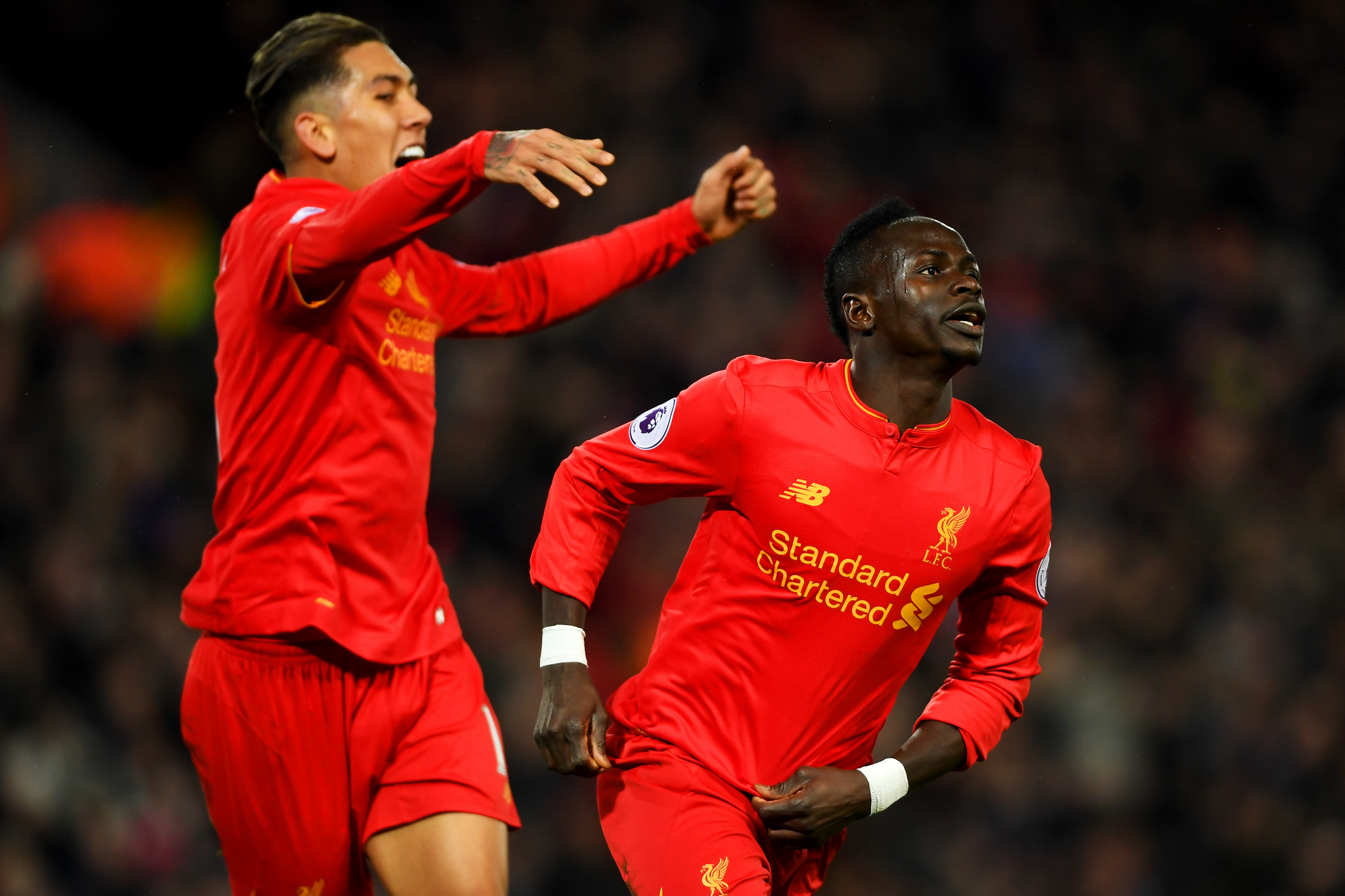 LIVERPOOL, ENGLAND - FEBRUARY 11:  Sadio Mane (R) of Liverpool celebrates scoring the oprning goal with his team mate Roberto Firmino (L) during the Premier League match between Liverpool and Tottenham Hotspur at Anfield on February 11, 2017 in Liverpool, England.  (Photo by Mike Hewitt/Getty Images for Tottenham Hotspur FC)