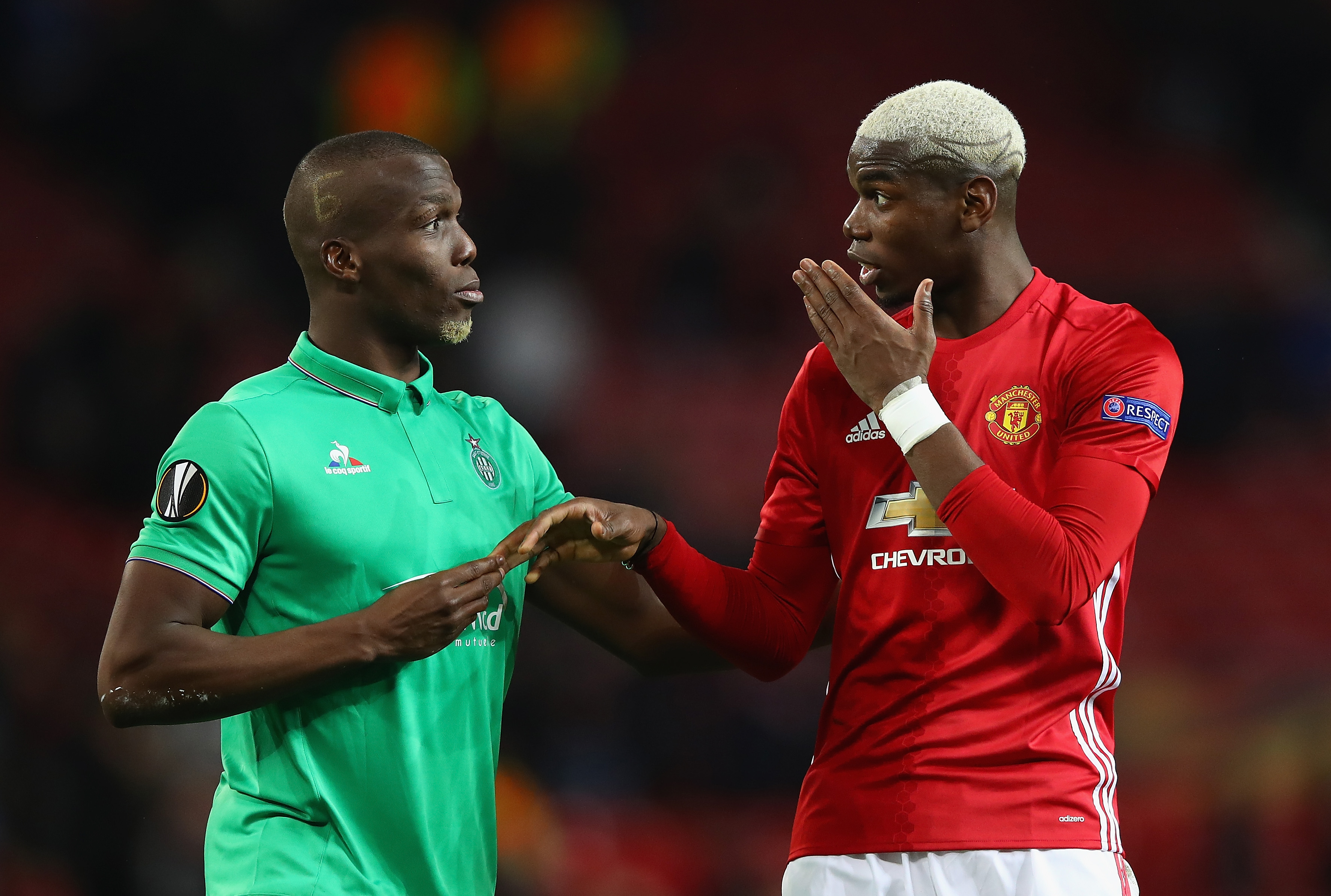 MANCHESTER, ENGLAND - FEBRUARY 16:  Paul Pogba of Manchester United (R) and Florentin Pogba of Saint Ettienne speak  during the UEFA Europa  League Round of 32 first leg match between Manchester United and AS Saint-Etienne at Old Trafford on February 16, 2017 in Manchester, United Kingdom.  (Photo by Clive Brunskill/Getty Images)
