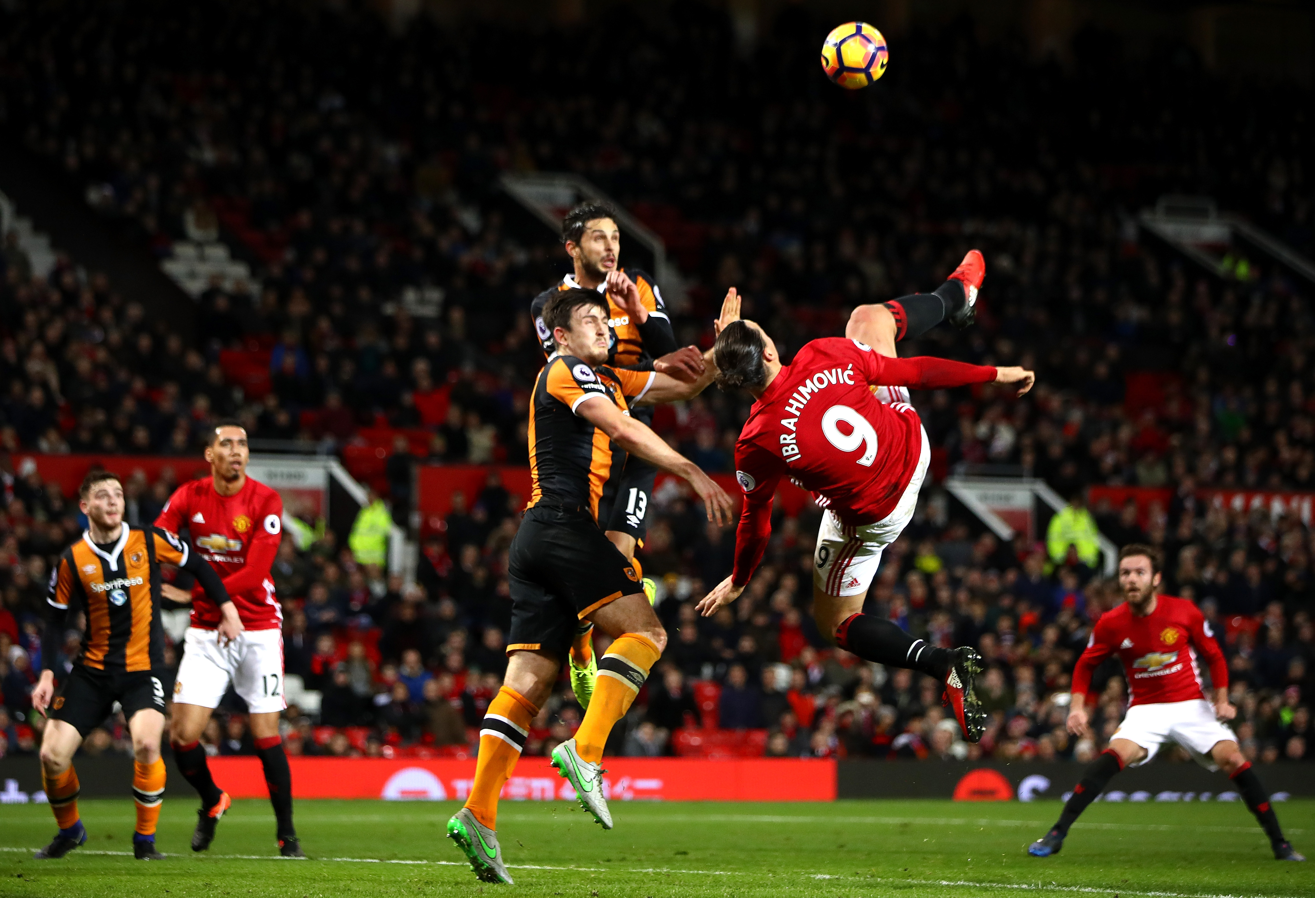 MANCHESTER, ENGLAND - FEBRUARY 01:  Zlatan Ibrahimovic of Manchester United performs an acrobatic kick with Harry Maguire and Andrea Ranocchia of Hull City during the Premier League match between Manchester United and Hull City at Old Trafford on February 1, 2017 in Manchester, England.  (Photo by Clive Mason/Getty Images)