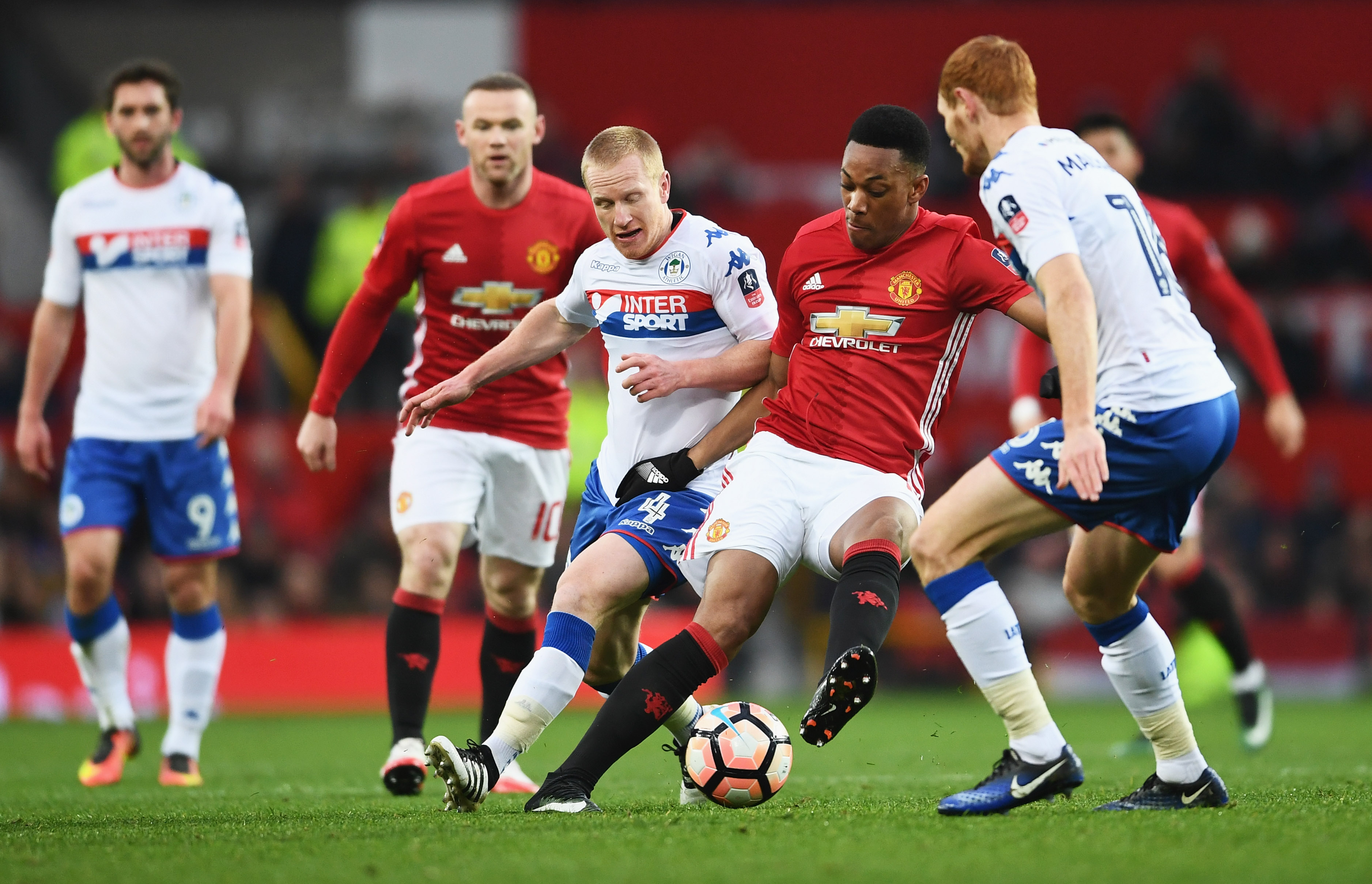 MANCHESTER, ENGLAND - JANUARY 29:  Anthony Martial of Manchester United battles with David Perkins and Shaun MacDonald of Wigan Athletic Anthony Martial of Manchester United during the Emirates FA Cup Fourth round match between Manchester United and Wigan Athletic at Old Trafford on January 29, 2017 in Manchester, England.  (Photo by Laurence Griffiths/Getty Images)
