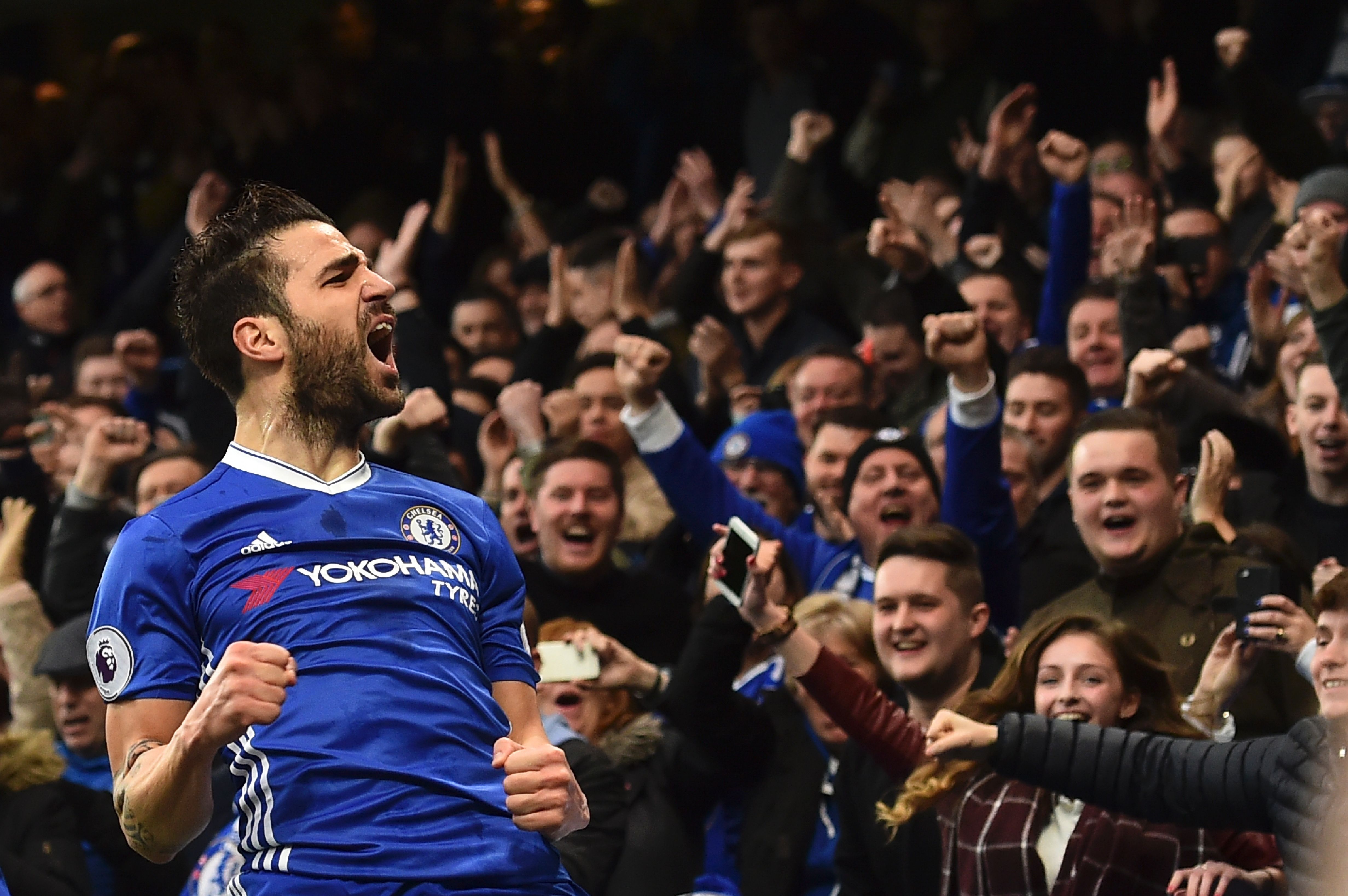 TOPSHOT - Chelsea's Spanish midfielder Cesc Fabregas celebrates scoring the opening goal during the English Premier League football match between Chelsea and Swansea at Stamford Bridge in London on February 25, 2017. / AFP / Glyn KIRK / RESTRICTED TO EDITORIAL USE. No use with unauthorized audio, video, data, fixture lists, club/league logos or 'live' services. Online in-match use limited to 75 images, no video emulation. No use in betting, games or single club/league/player publications.  /         (Photo credit should read GLYN KIRK/AFP/Getty Images)