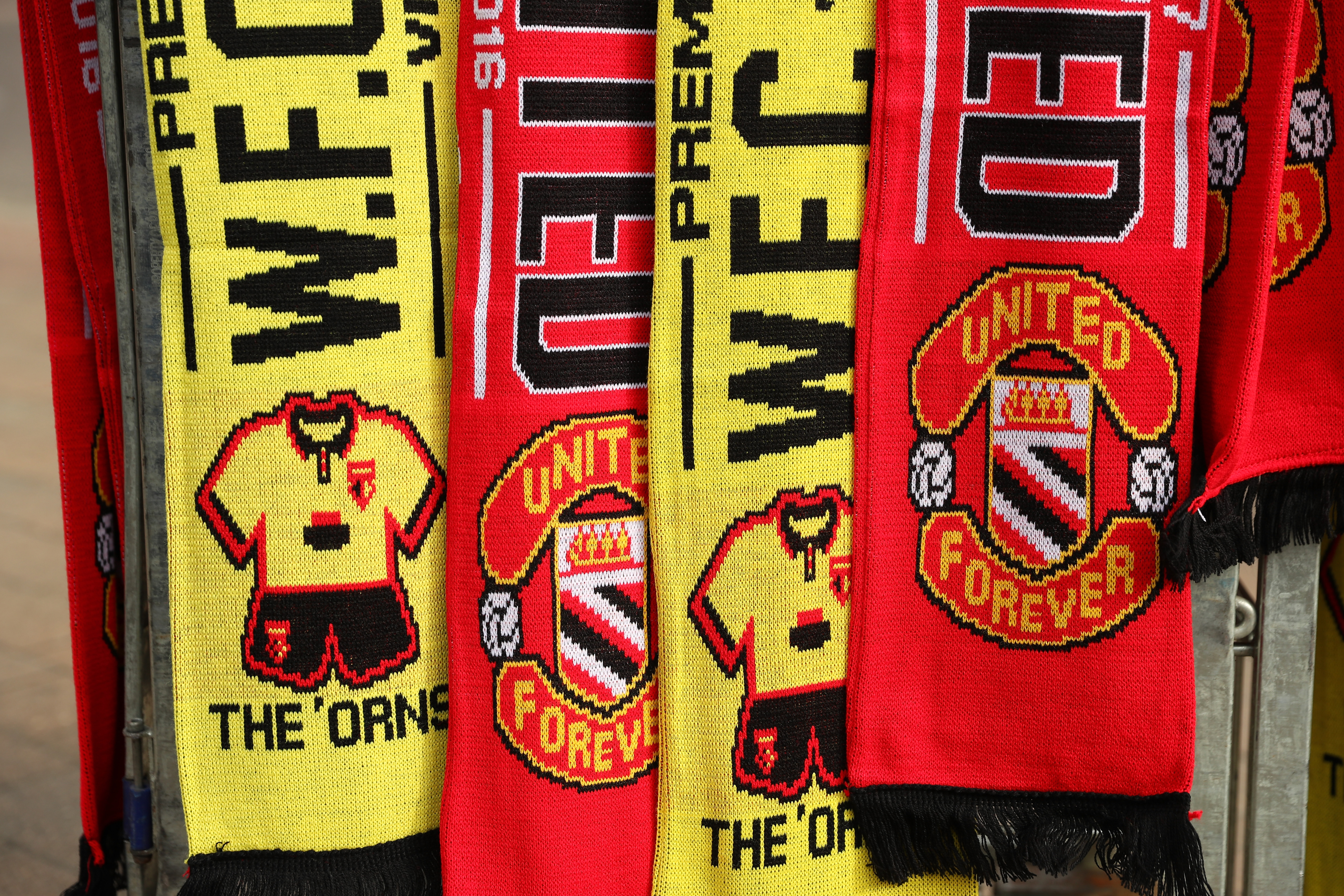 WATFORD, ENGLAND - SEPTEMBER 18:  Half and half scarfs being sold outside the stadium during the Premier League match between Watford and Manchester United at Vicarage Road on September 18, 2016 in Watford, England.  (Photo by Richard Heathcote/Getty Images)