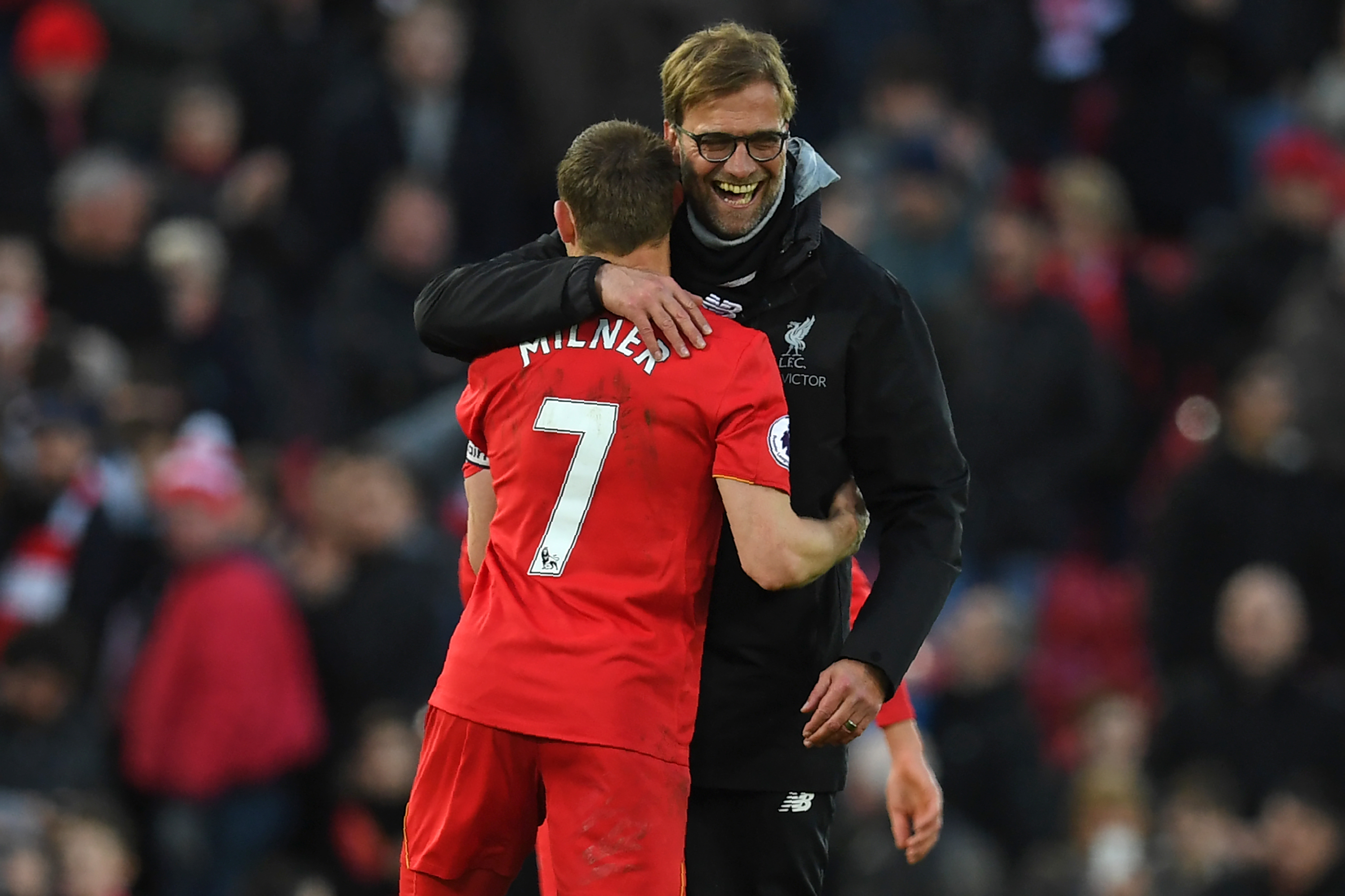 Liverpool's German manager Jurgen Klopp (R) embraces Liverpool's English midfielder James Milner after the English Premier League football match between Liverpool and Burnley at Anfield in Liverpool, north west England on March 12, 2017.
Liverpool won the game 2-1. / AFP PHOTO / Paul ELLIS / RESTRICTED TO EDITORIAL USE. No use with unauthorized audio, video, data, fixture lists, club/league logos or 'live' services. Online in-match use limited to 75 images, no video emulation. No use in betting, games or single club/league/player publications.  /         (Photo credit should read PAUL ELLIS/AFP/Getty Images)