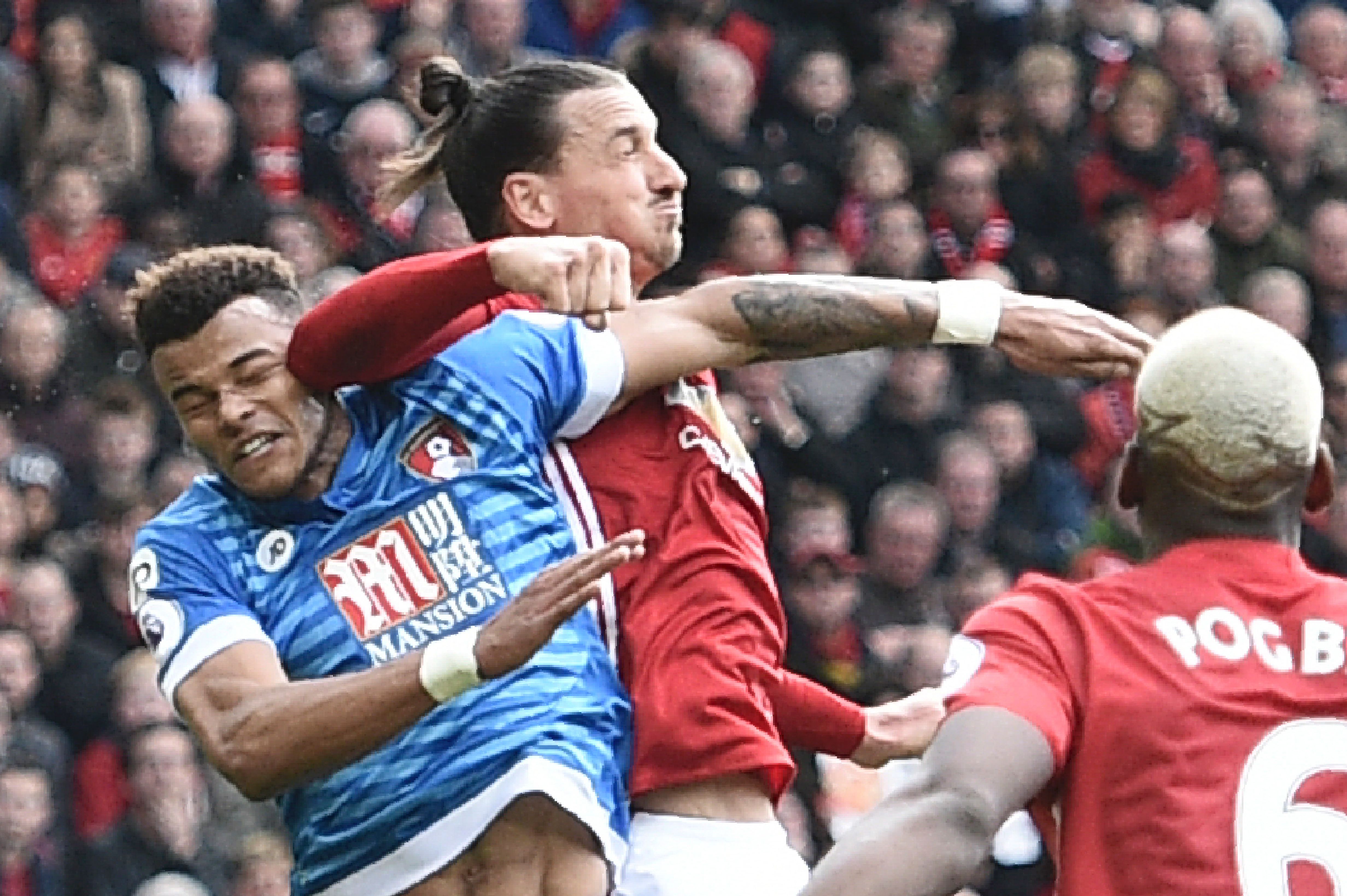 Manchester United's Swedish striker Zlatan Ibrahimovic (2L) clashes in the air with Bournemouth's English defender Tyrone Mings (L) during the English Premier League football match between Manchester United and Bournemouth at Old Trafford in Manchester, north west England, on March 4, 2017. / AFP PHOTO / Oli SCARFF / RESTRICTED TO EDITORIAL USE. No use with unauthorized audio, video, data, fixture lists, club/league logos or 'live' services. Online in-match use limited to 75 images, no video emulation. No use in betting, games or single club/league/player publications.  /         (Photo credit should read OLI SCARFF/AFP/Getty Images)