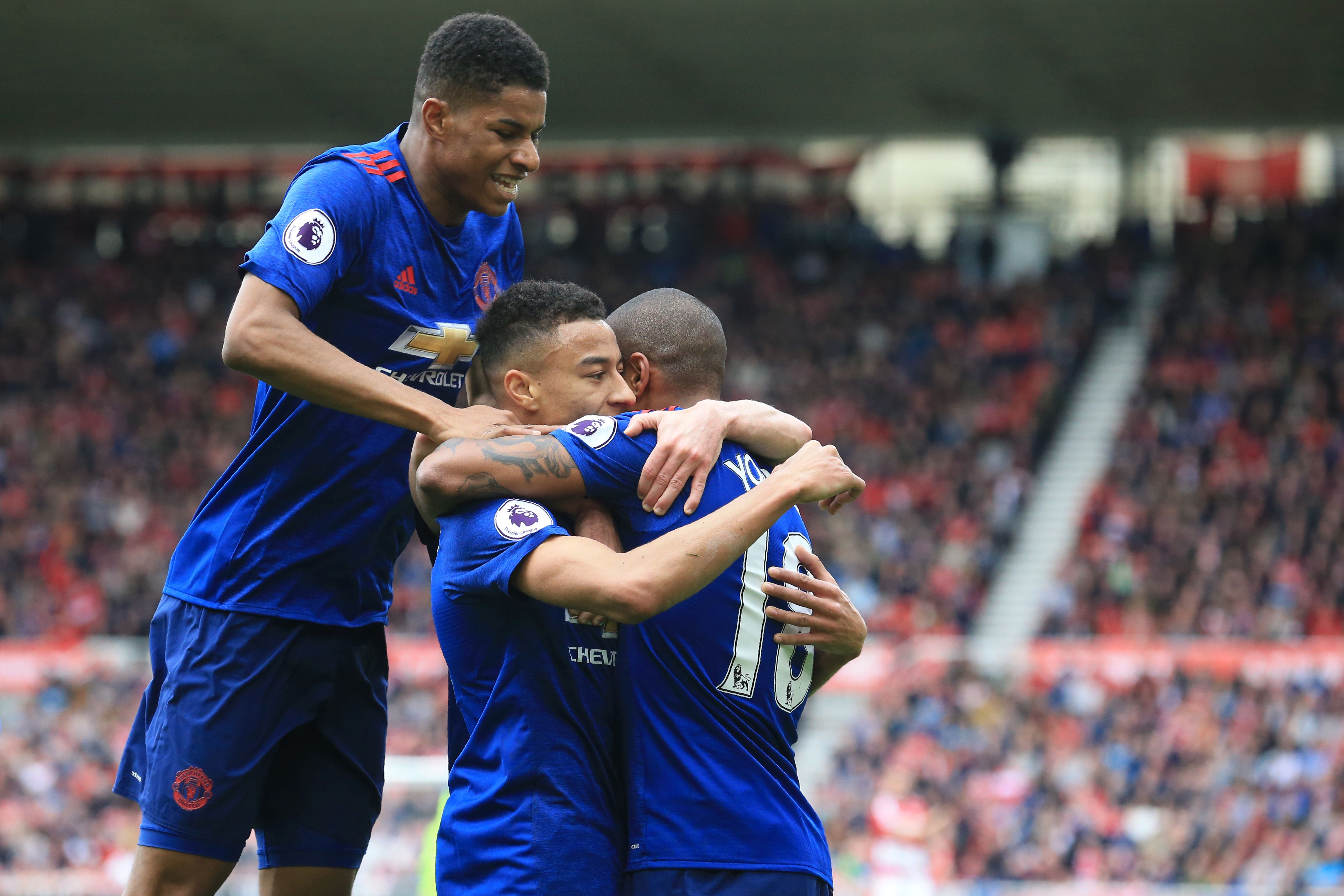 Manchester United's English midfielder Jesse Lingard (C) celebrates with Manchester United's English midfielder Ashley Young (R) and Manchester United's English striker Marcus Rashford (L) after scoring their second goal during the English Premier League football match between Middlesbrough and Manchester United at Riverside Stadium in Middlesbrough, north east England on March 19, 2017. / AFP PHOTO / Lindsey PARNABY / RESTRICTED TO EDITORIAL USE. No use with unauthorized audio, video, data, fixture lists, club/league logos or 'live' services. Online in-match use limited to 75 images, no video emulation. No use in betting, games or single club/league/player publications.  /         (Photo credit should read LINDSEY PARNABY/AFP/Getty Images)