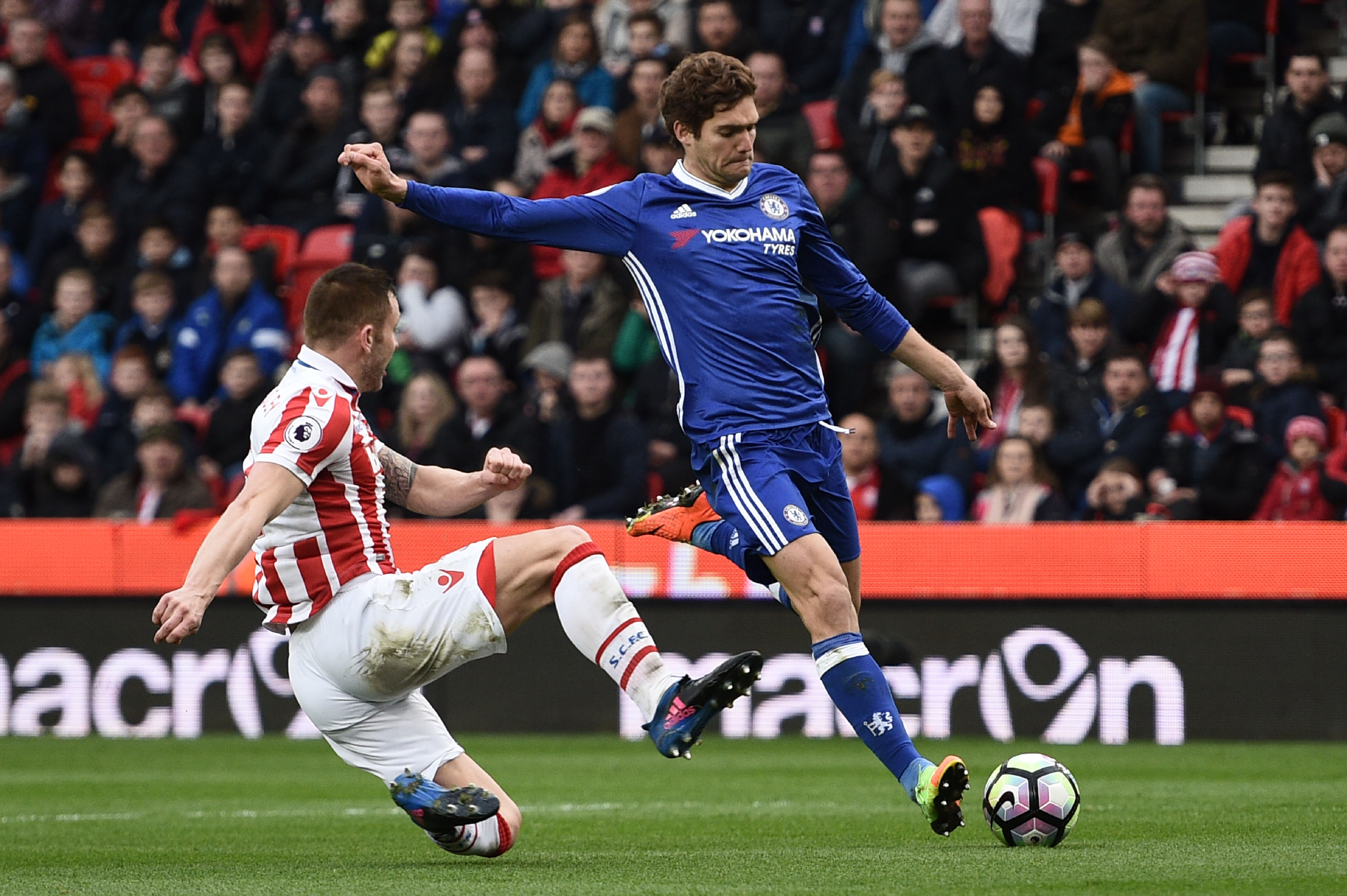 Stoke City's English-born Scottish defender Phil Bardsley (L) tries to block a shot by Chelsea's Spanish defender Marcos Alonso during the English Premier League football match between Stoke City and Chelsea at the Bet365 Stadium in Stoke-on-Trent, central England on March 18, 2017. / AFP PHOTO / Oli SCARFF / RESTRICTED TO EDITORIAL USE. No use with unauthorized audio, video, data, fixture lists, club/league logos or 'live' services. Online in-match use limited to 75 images, no video emulation. No use in betting, games or single club/league/player publications.  /         (Photo credit should read OLI SCARFF/AFP/Getty Images)