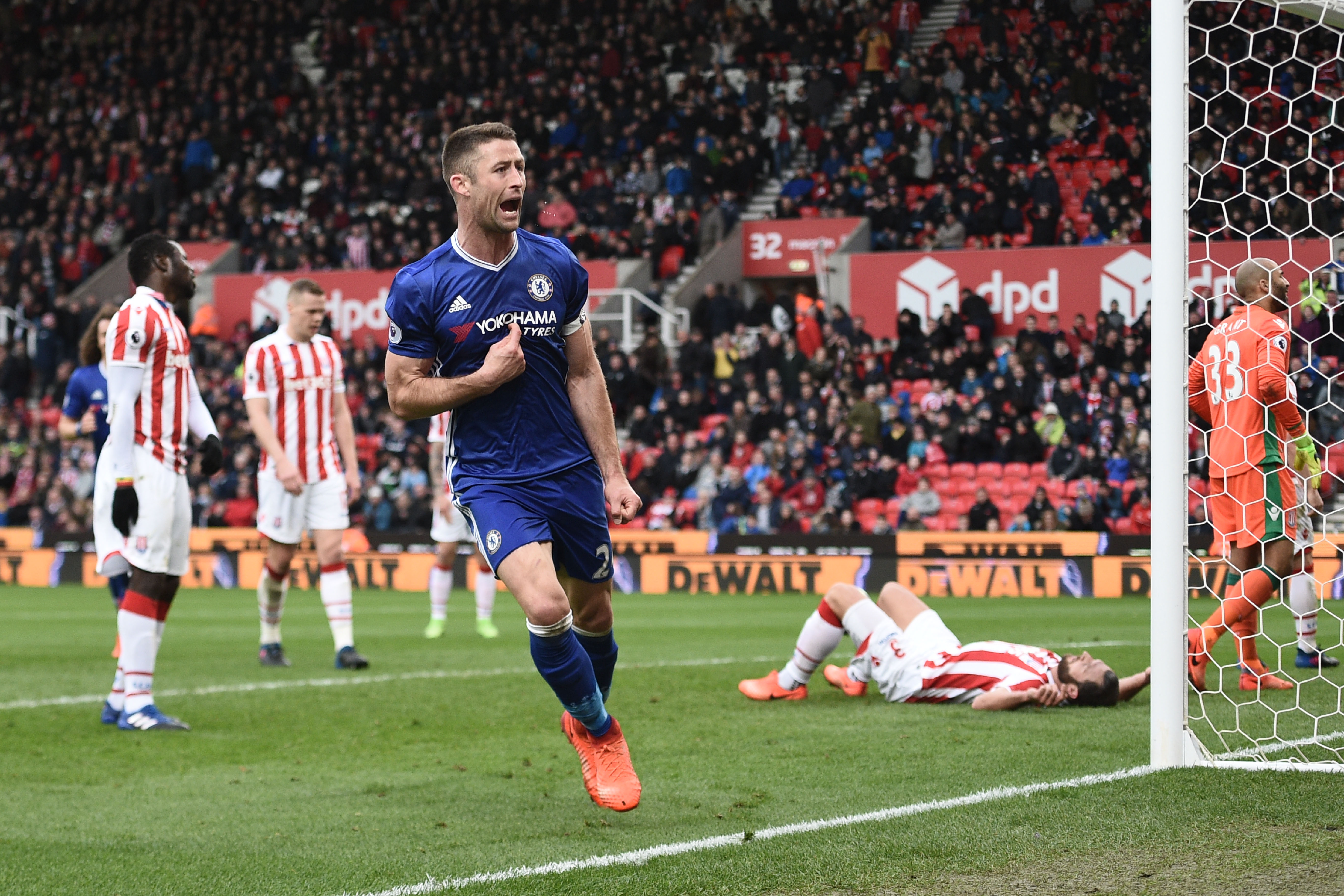 Chelsea's English defender Gary Cahill (C) celebrates after scoring their second goal during the English Premier League football match between Stoke City and Chelsea at the Bet365 Stadium in Stoke-on-Trent, central England on March 18, 2017. / AFP PHOTO / Oli SCARFF / RESTRICTED TO EDITORIAL USE. No use with unauthorized audio, video, data, fixture lists, club/league logos or 'live' services. Online in-match use limited to 75 images, no video emulation. No use in betting, games or single club/league/player publications.  /         (Photo credit should read OLI SCARFF/AFP/Getty Images)