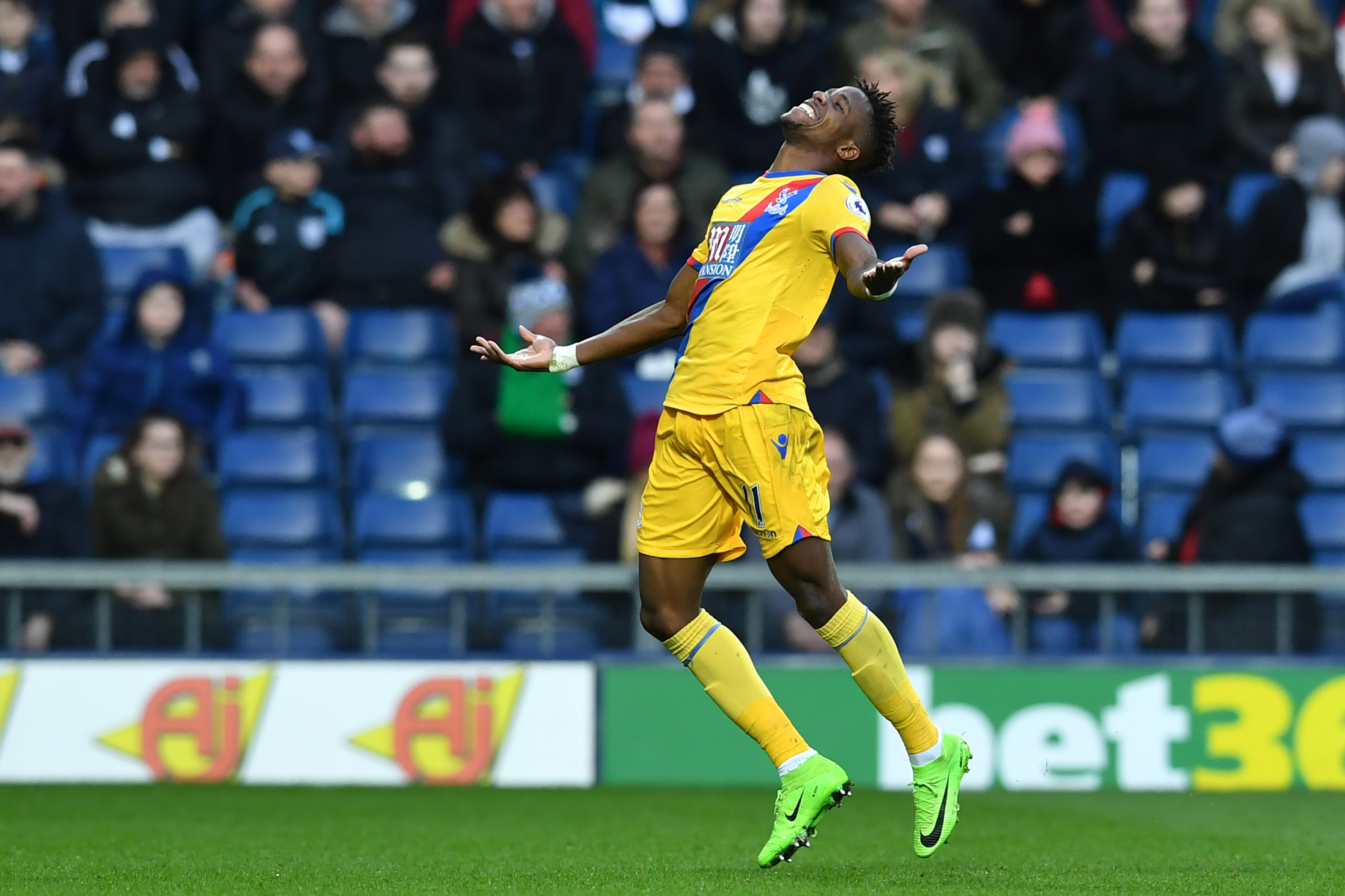 Crystal Palace's Ivorian-born English striker Wilfried Zaha celebrates after scoring the opening goal of the English Premier League football match between West Bromwich Albion and Crystal Palace at The Hawthorns stadium in West Bromwich, central England, on March 4, 2017.
 / AFP PHOTO / Ben STANSALL / RESTRICTED TO EDITORIAL USE. No use with unauthorized audio, video, data, fixture lists, club/league logos or 'live' services. Online in-match use limited to 75 images, no video emulation. No use in betting, games or single club/league/player publications.  /         (Photo credit should read BEN STANSALL/AFP/Getty Images)