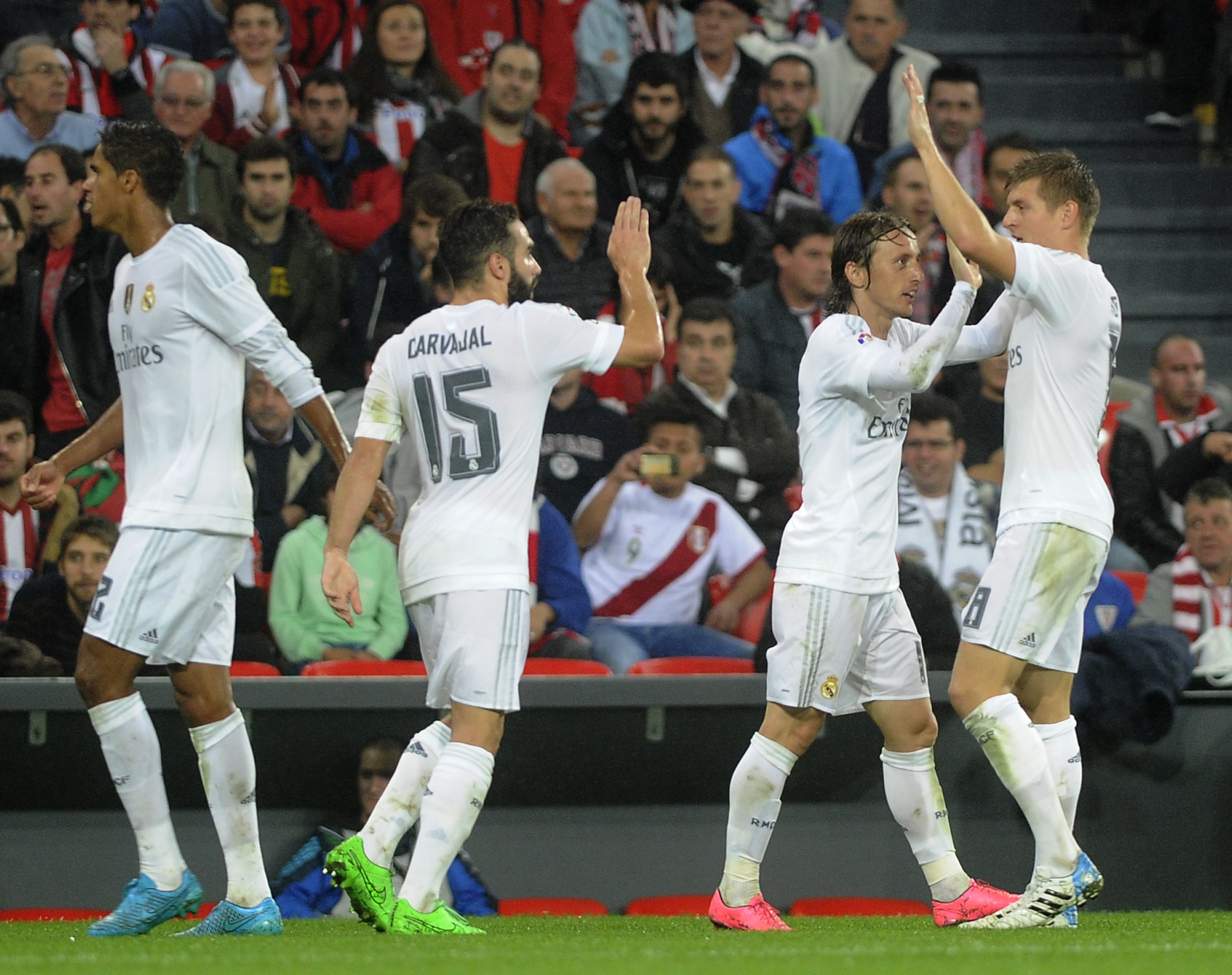 (From L to R) Real Madrid's French defender Raphael Varane, defender Daniel Carvajal, Croatian midfielder Luka Modric and German midfielder Toni Kroos celebrate after scoring during the Spanish league football match Athletic Club vs Real Madrid CF at the San Mames stadium in Bilbao on September 23, 2015. AFP PHOTO / ANDER GILLENEA        (Photo credit should read ANDER GILLENEA/AFP/Getty Images)
