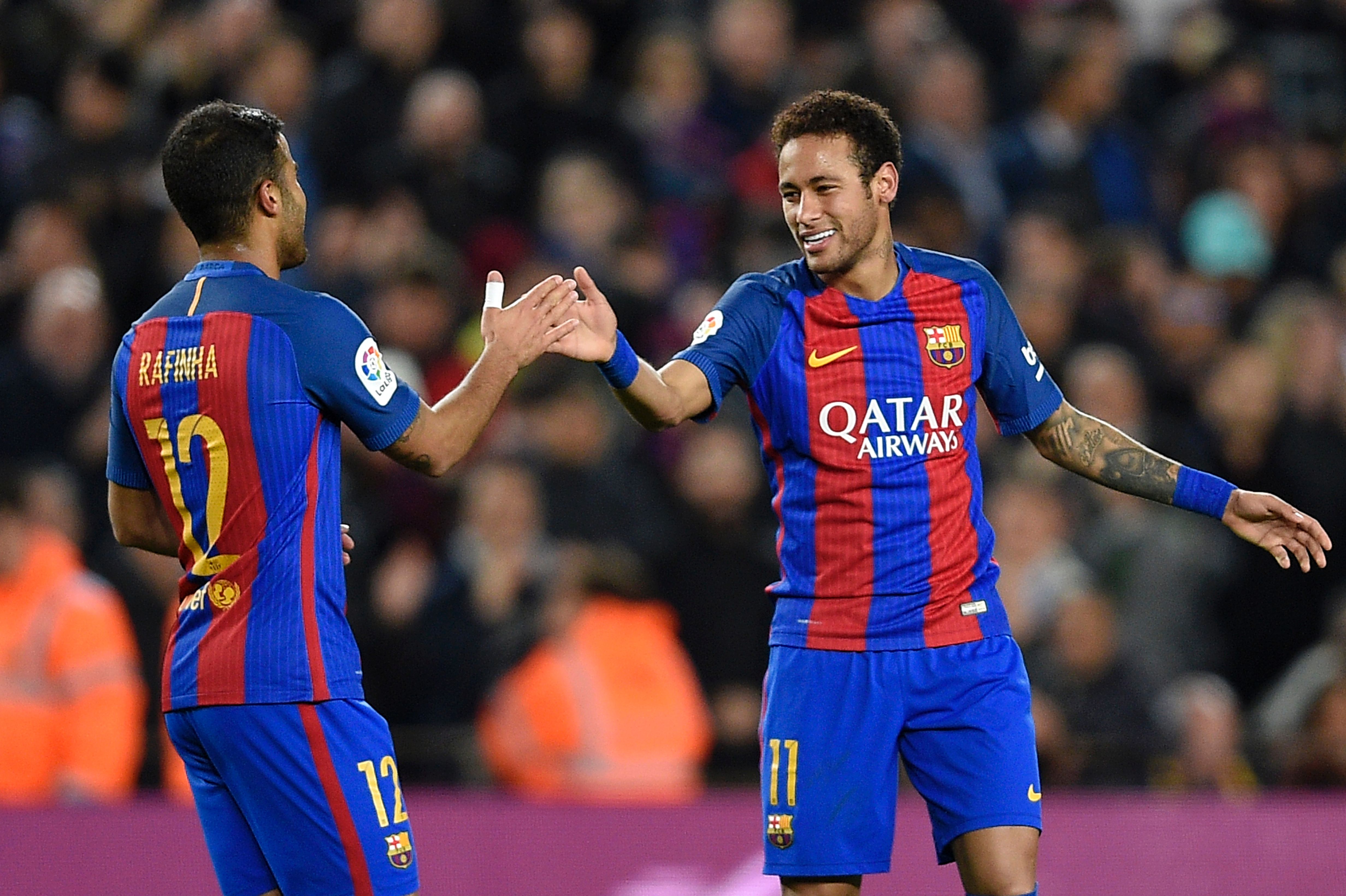 Barcelona's Brazilian forward Neymar (R) celebrates with Barcelona's Brazilian midfielder Rafinha after scoring during the Spanish league football match FC Barcelona vs Real Sporting de Gijon at the Camp Nou stadium in Barcelona on March 1, 2017. / AFP PHOTO / LLUIS GENE        (Photo credit should read LLUIS GENE/AFP/Getty Images)