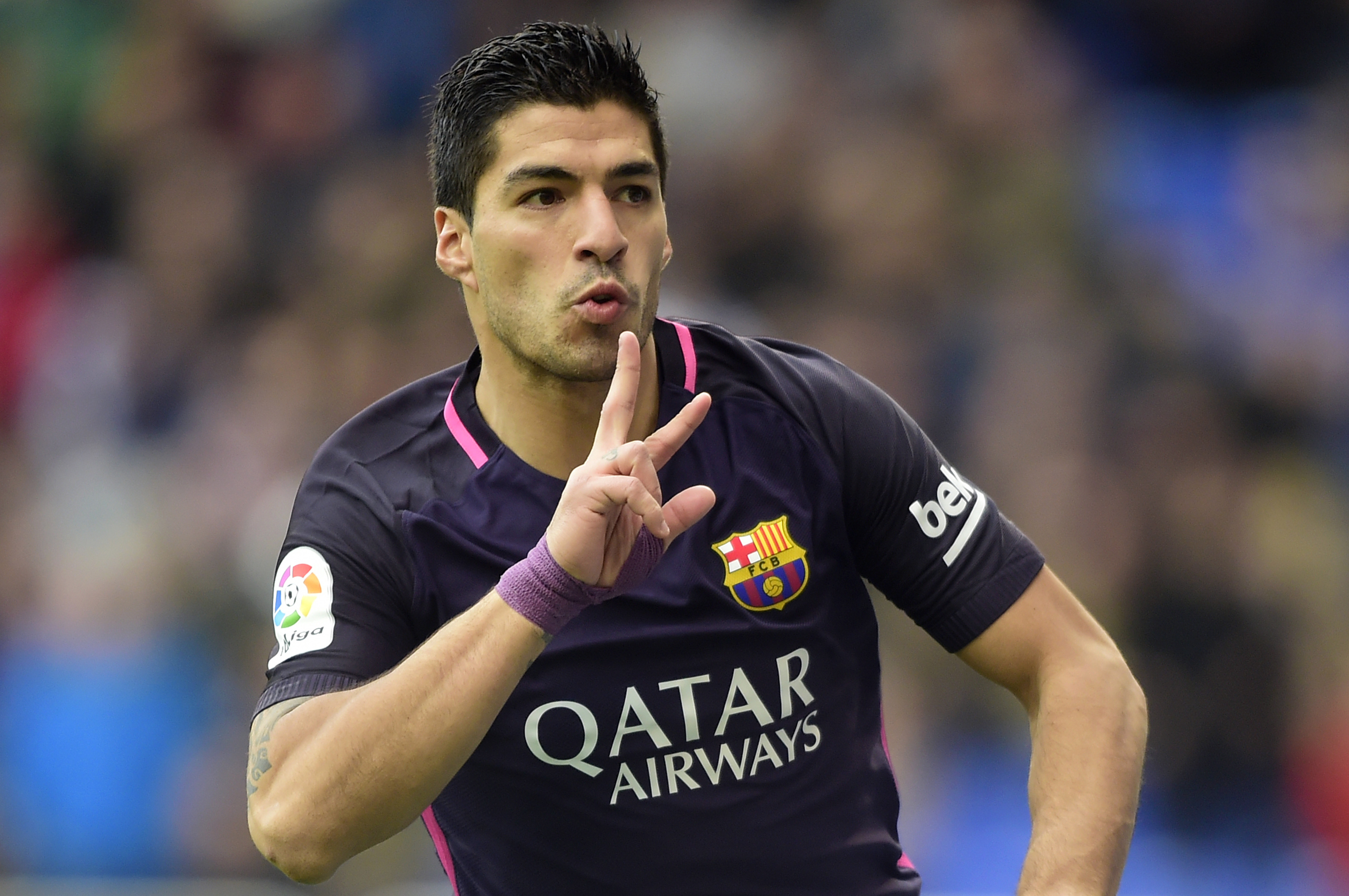 Barcelona's Uruguayan forward Luis Suarez celebrates after scoring during the Spanish league football match RC Deportivo de la Coruna vs FC Barcelona at the Municipal de Riazor stadium in La Coruna on March 12, 2017. / AFP PHOTO / MIGUEL RIOPA        (Photo credit should read MIGUEL RIOPA/AFP/Getty Images)