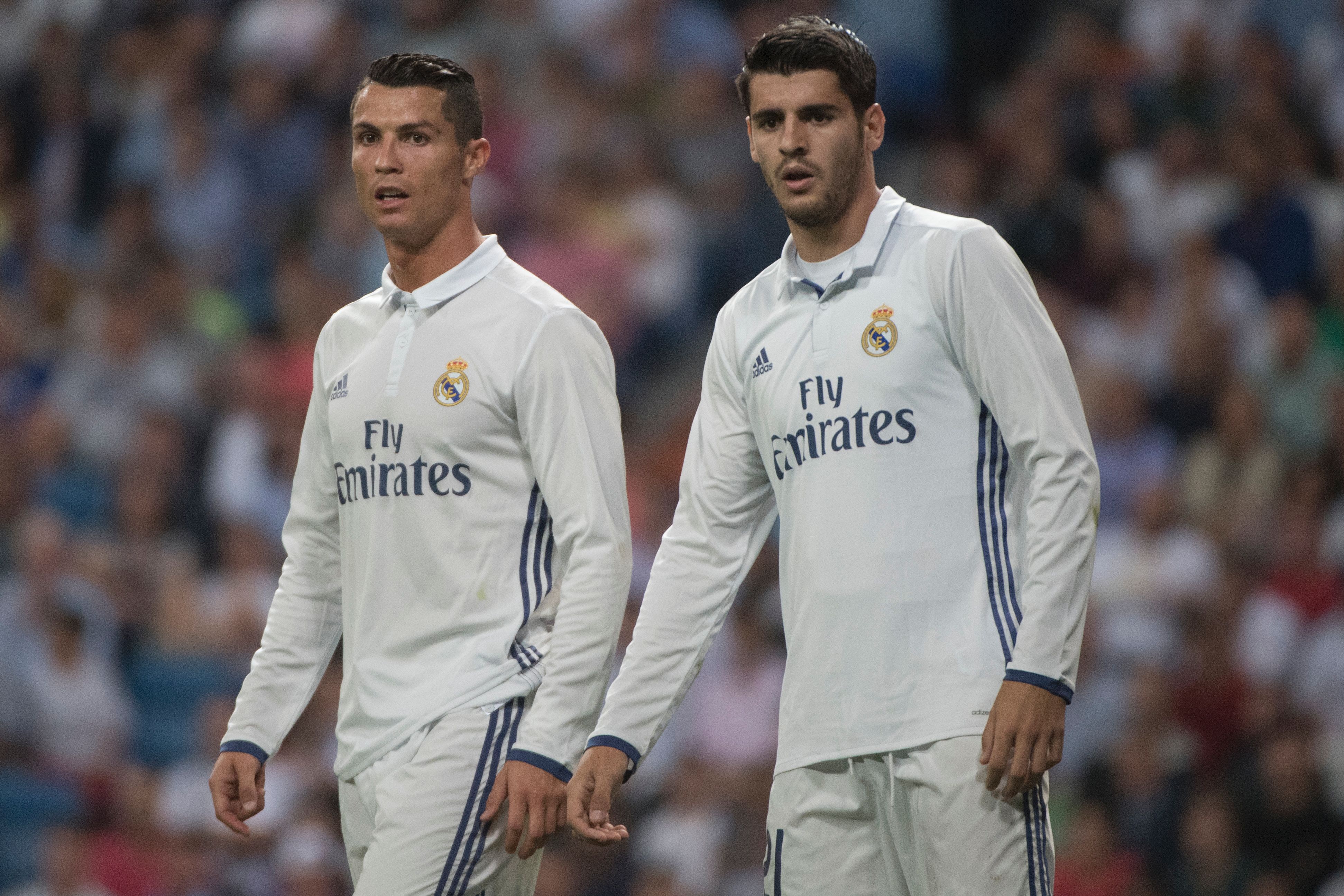 Real Madrid's Portuguese forward Cristiano Ronaldo (L) and Real Madrid's forward Alvaro Morata look on during the Spanish league football match Real Madrid CF vs Villarreal CF at the Santiago Bernabeu stadium in Madrid on September 21, 2016. / AFP / CURTO DE LA TORRE        (Photo credit should read CURTO DE LA TORRE/AFP/Getty Images)