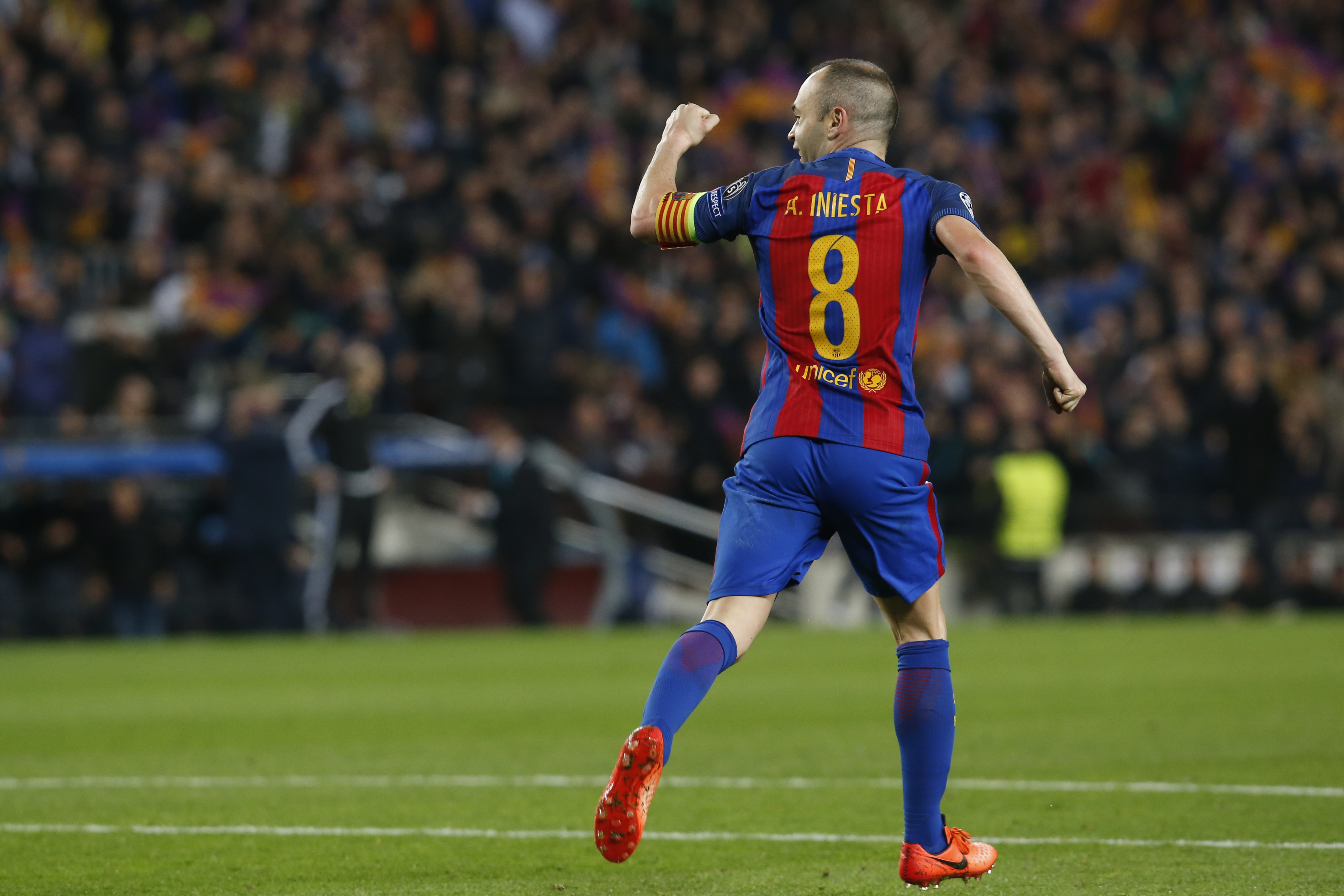 Barcelona's midfielder Andres Iniesta celebrates Paris Saint-Germain's own goal during the UEFA Champions League round of 16 second leg football match FC Barcelona vs Paris Saint-Germain FC at the Camp Nou stadium in Barcelona on March 8, 2017. / AFP PHOTO / PAU BARRENA        (Photo credit should read PAU BARRENA/AFP/Getty Images)