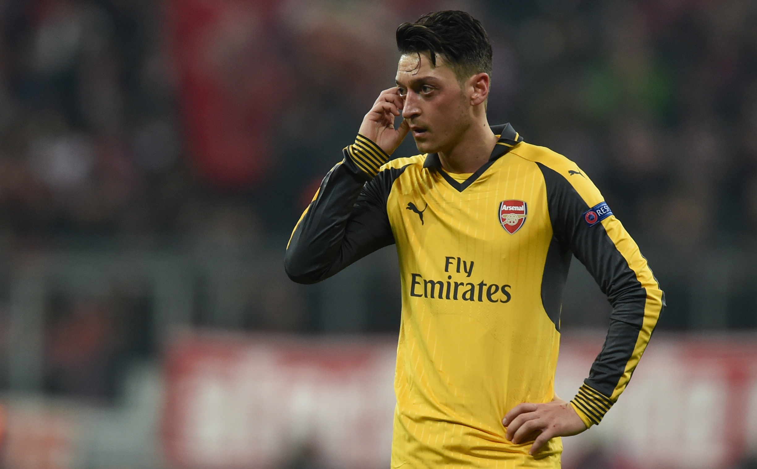 Arsenal's German midfielder Mesut Ozil reacts during the UEFA Champions League round of sixteen football match between FC Bayern Munich and Arsenal in Munich, southern Germany, on February 15, 2017.  / AFP / Christof STACHE        (Photo credit should read CHRISTOF STACHE/AFP/Getty Images)