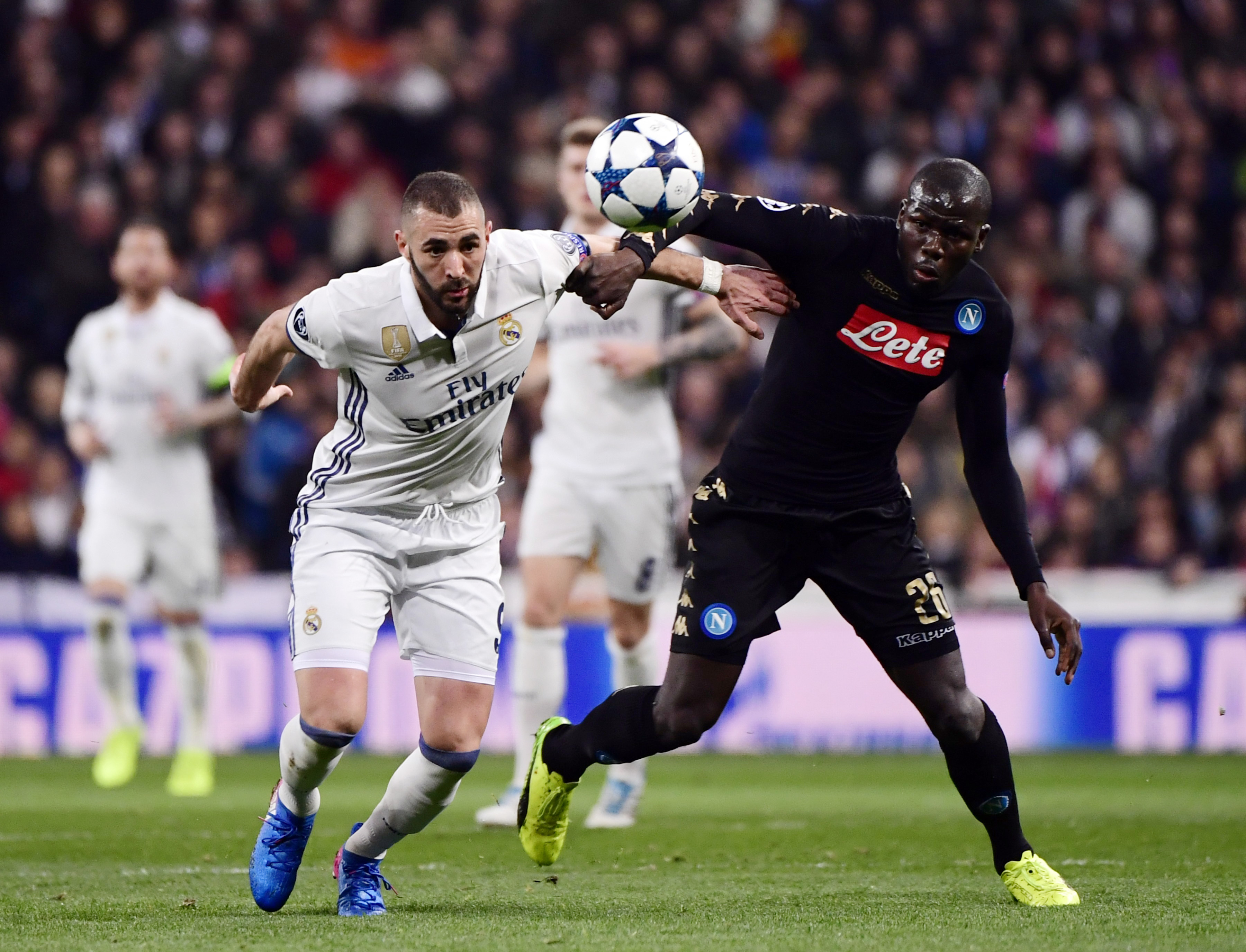 Real Madrid's French forward Karim Benzema (L) vies with Napoli's defender from France Kalidou Koulibaly during the UEFA Champions League round of 16 first leg football match Real Madrid CF vs SSC Napoli at the Santiago Bernabeu stadium in Madrid on February 15, 2017. / AFP / PIERRE-PHILIPPE MARCOU        (Photo credit should read PIERRE-PHILIPPE MARCOU/AFP/Getty Images)