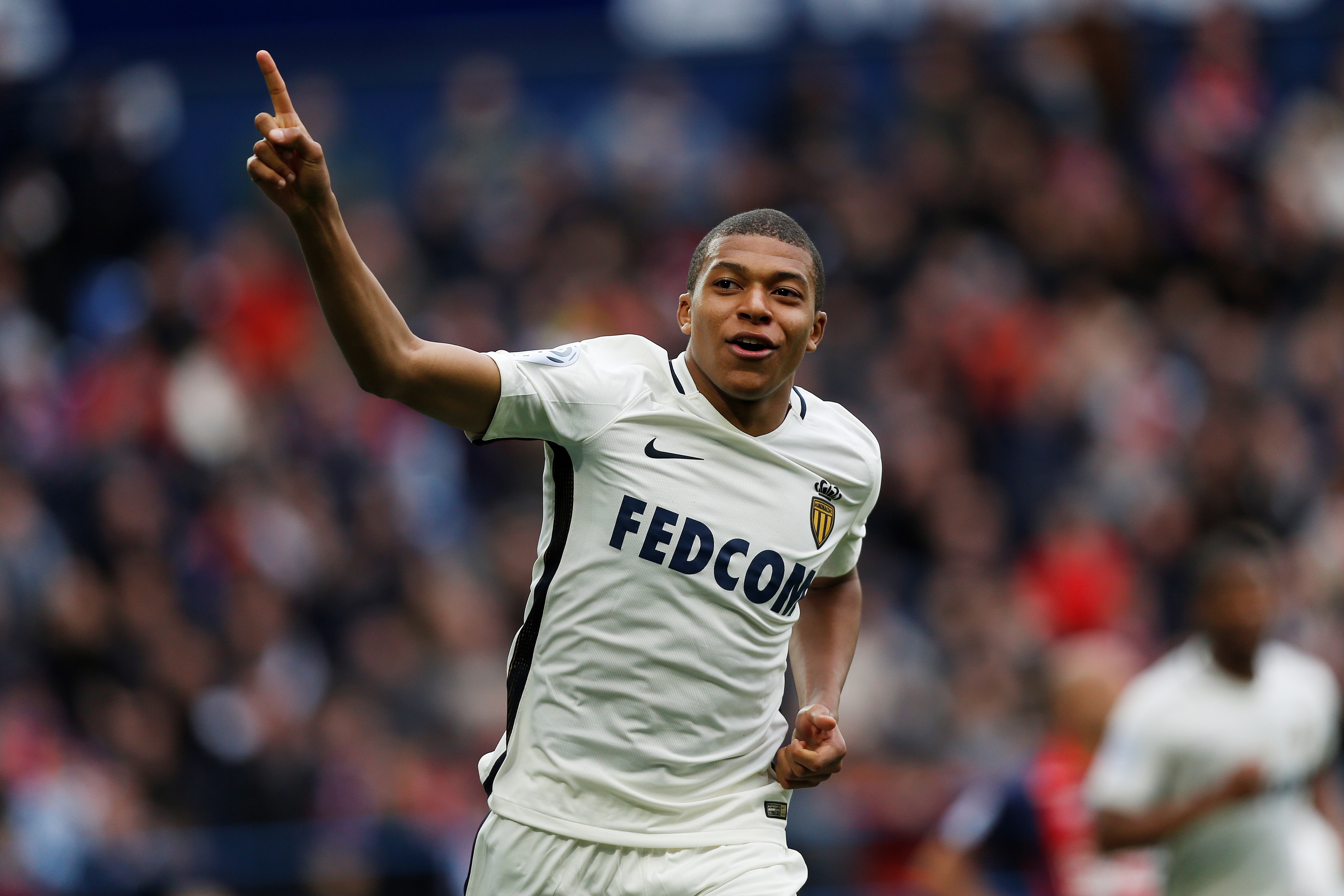 Monaco's French forward Kylian Mbappe Lottin celebrates after scoring a goal during the French L1 football match between Caen (SMC) and Monaco (AS), on March 19, 2017 at the Michel d'Ornano stadium, in Caen, northwestern France. / AFP PHOTO / CHARLY TRIBALLEAU        (Photo credit should read CHARLY TRIBALLEAU/AFP/Getty Images)