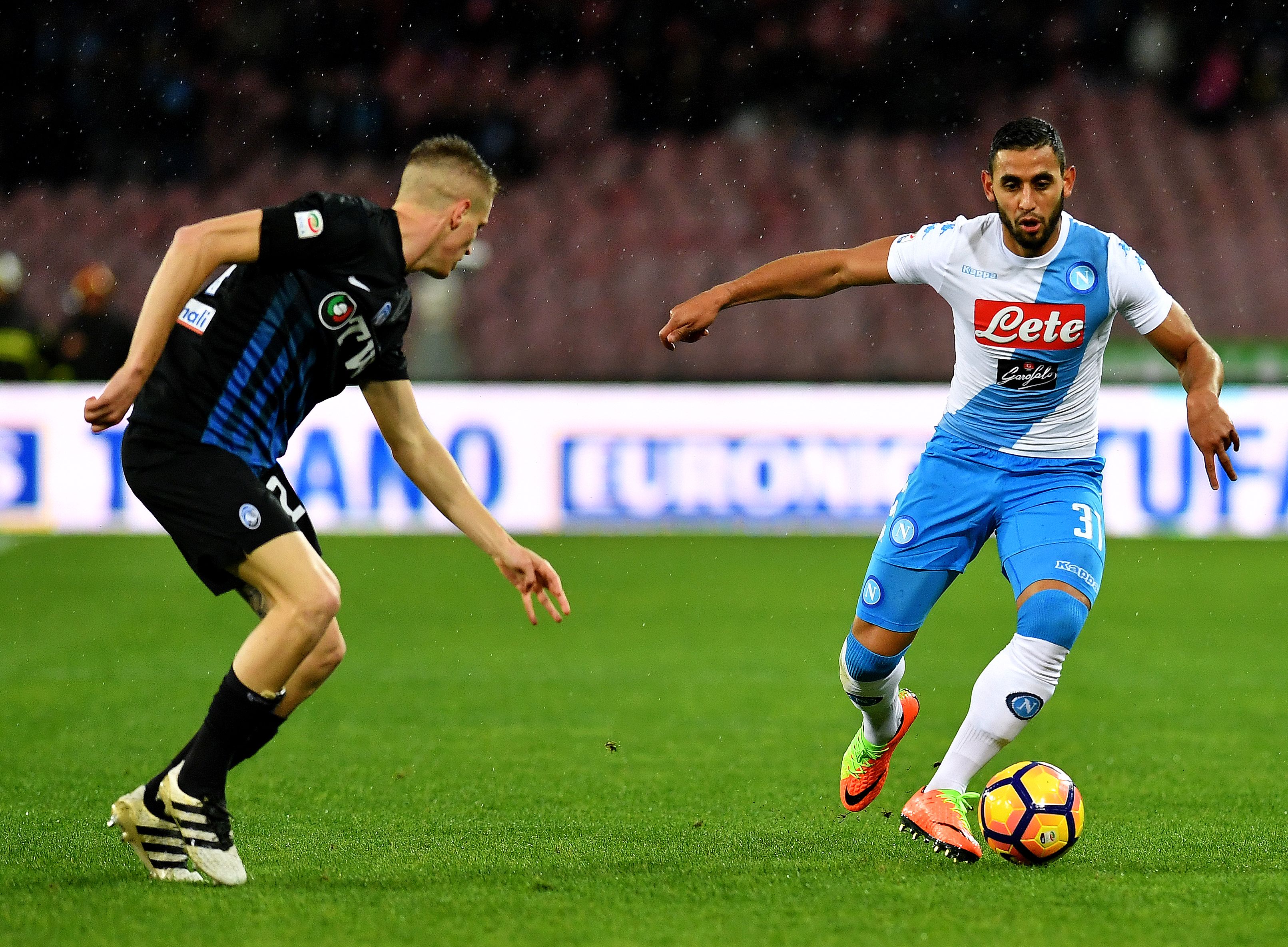 Napoli's defender from Algeria Faouzi Ghoulam (R) fights for the ball with Atalanta's defender Andrea Conti during the Italian Serie A football match between Napoli and Atalanta on February 25, 2017 at San Paolo stadium in Naples. / AFP / ALBERTO PIZZOLI        (Photo credit should read ALBERTO PIZZOLI/AFP/Getty Images)