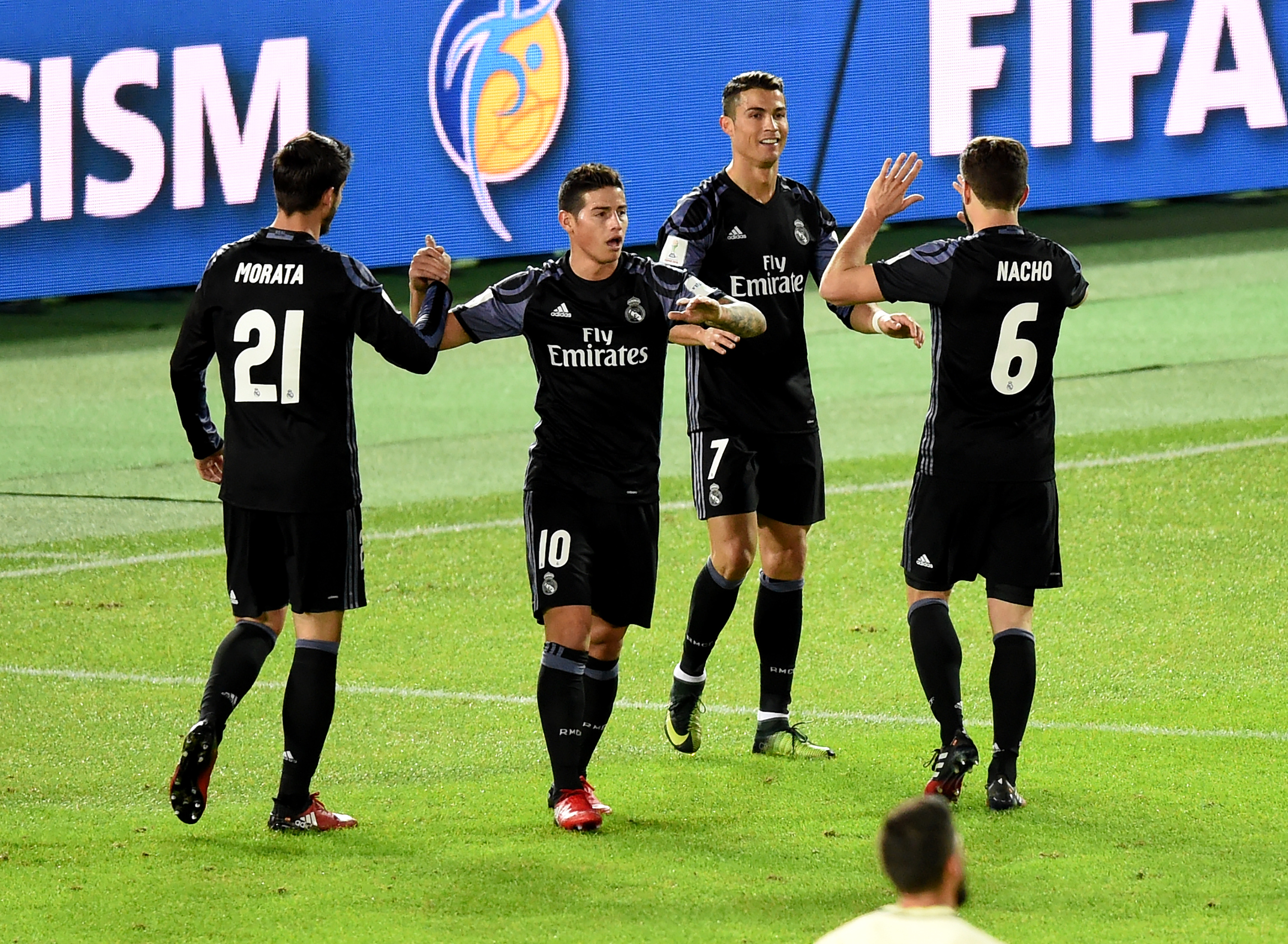 Real Madrid's forward Cristiano Ronaldo (2nd R) is congratulated by teammates Alvaro Morata (#21), James Rodriguez (2nd L) and Nacho Fernande (#6) after scoring a goal during the Club World Cup semi-final football match between Mexico's Club America and Spain's Real Madrid at Yokohama International stadium in Yokohama on December 15, 2016. / AFP / TORU YAMANAKA        (Photo credit should read TORU YAMANAKA/AFP/Getty Images)