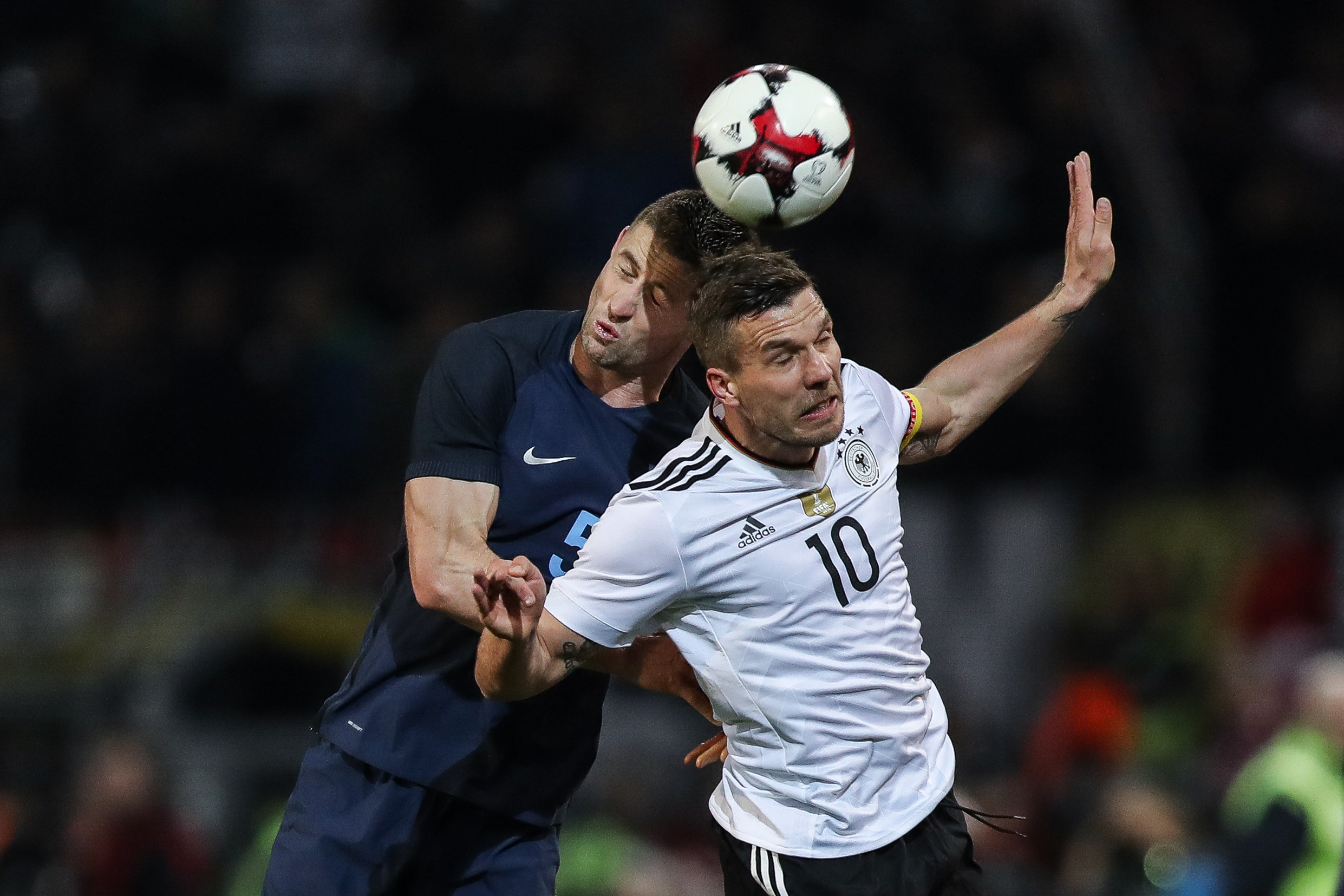 DORTMUND, GERMANY - MARCH 22:  Lukas Podolski of Germany and Gary Cahill of England battle for the ball during the international friendly match between Germany and England at Signal Iduna Park on March 22, 2017 in Dortmund, Germany. (Photo by Maja Hitij/Bongarts/Getty Images)