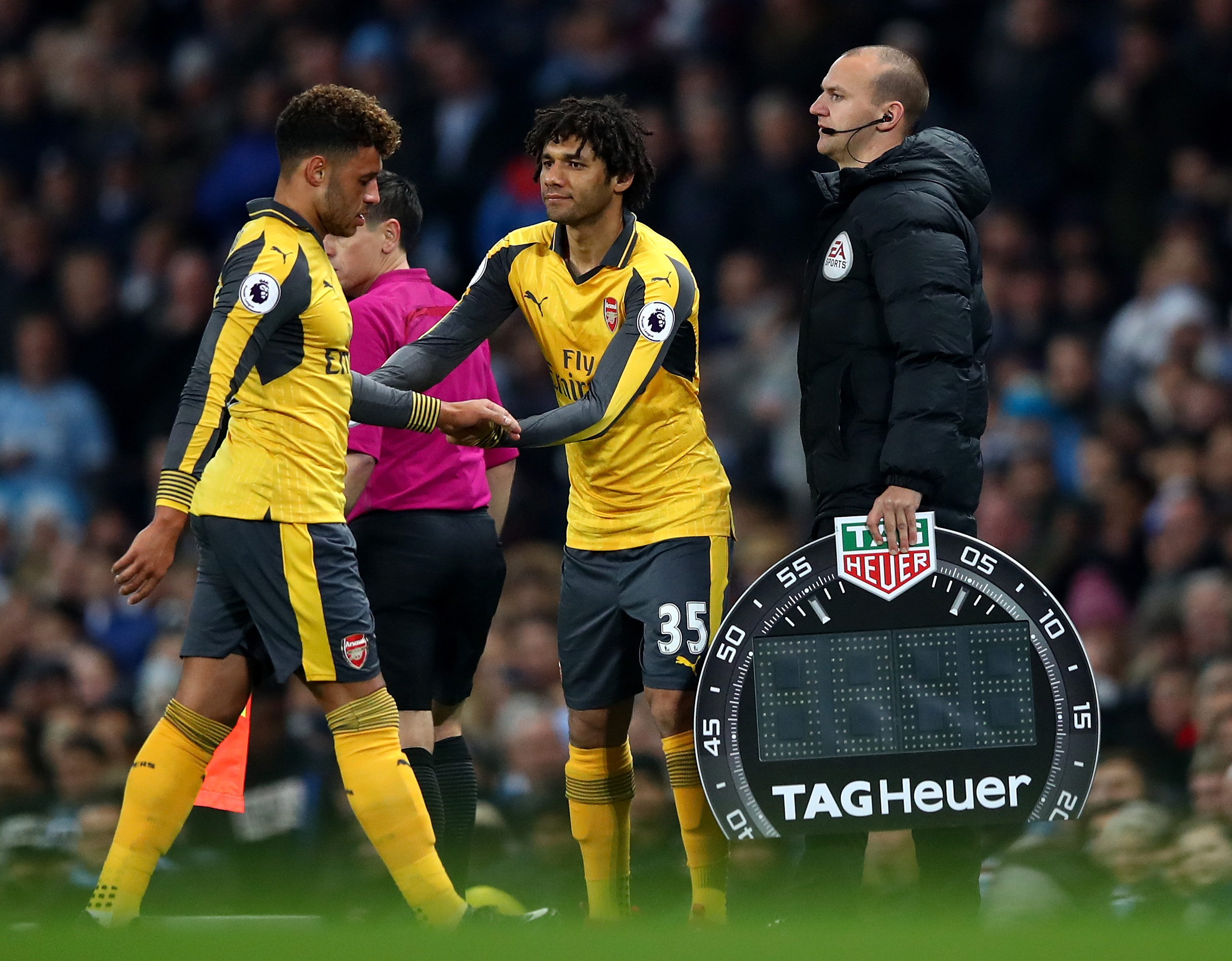 MANCHESTER, ENGLAND - DECEMBER 18:Alex Oxlade-Chamberlain of Arsenal (L) is subbed off for Mohamed Elneny of Arsenal (R)  during the Premier League match between Manchester City and Arsenal at the Etihad Stadium on December 18, 2016 in Manchester, England.  (Photo by Clive Brunskill/Getty Images)