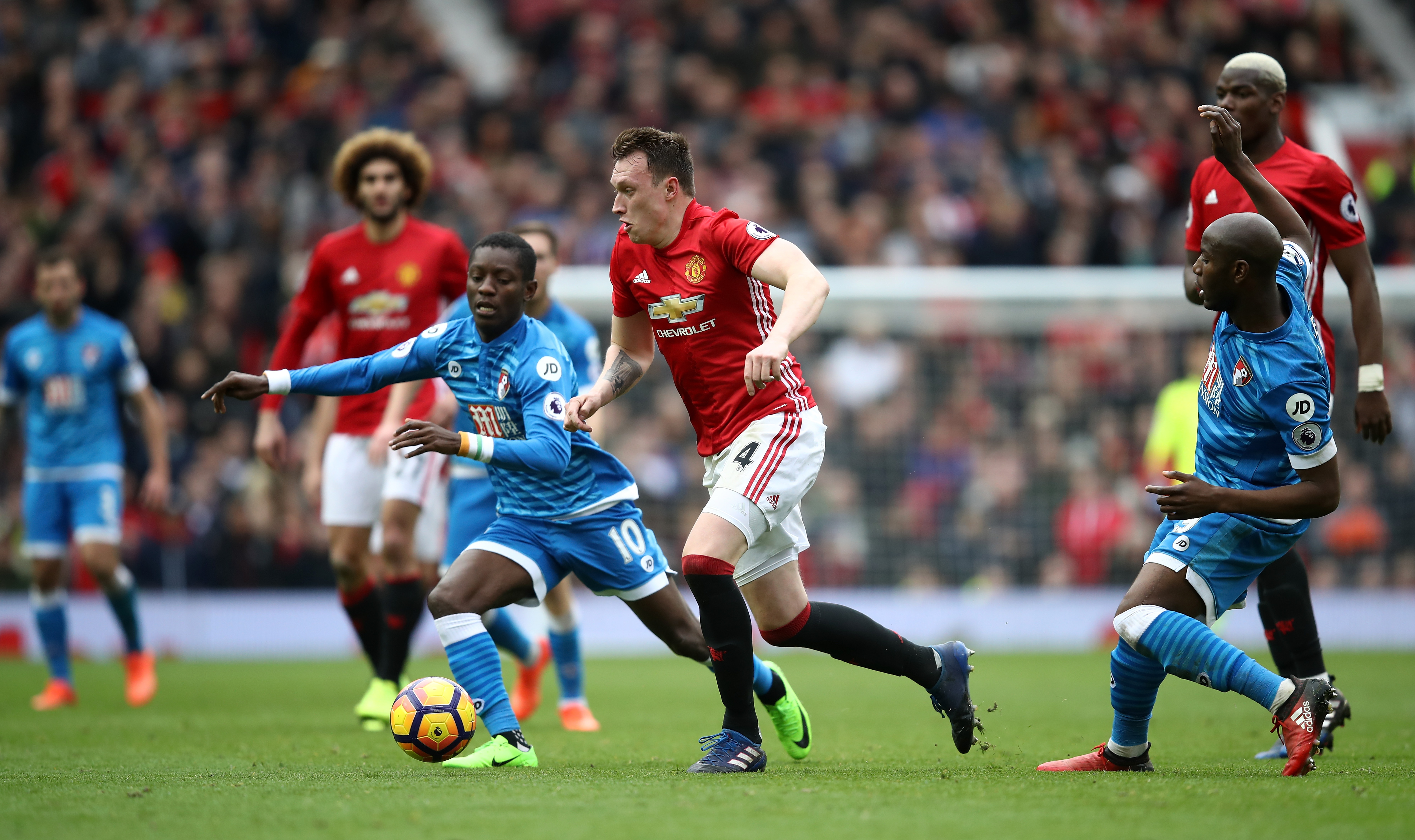 MANCHESTER, ENGLAND - MARCH 04: Max Gradel of AFC Bournemouth (L) attempts to take the ball the past Phil Jones of Manchester United (C) during the Premier League match between Manchester United and AFC Bournemouth at Old Trafford on March 4, 2017 in Manchester, England.  (Photo by Julian Finney/Getty Images)