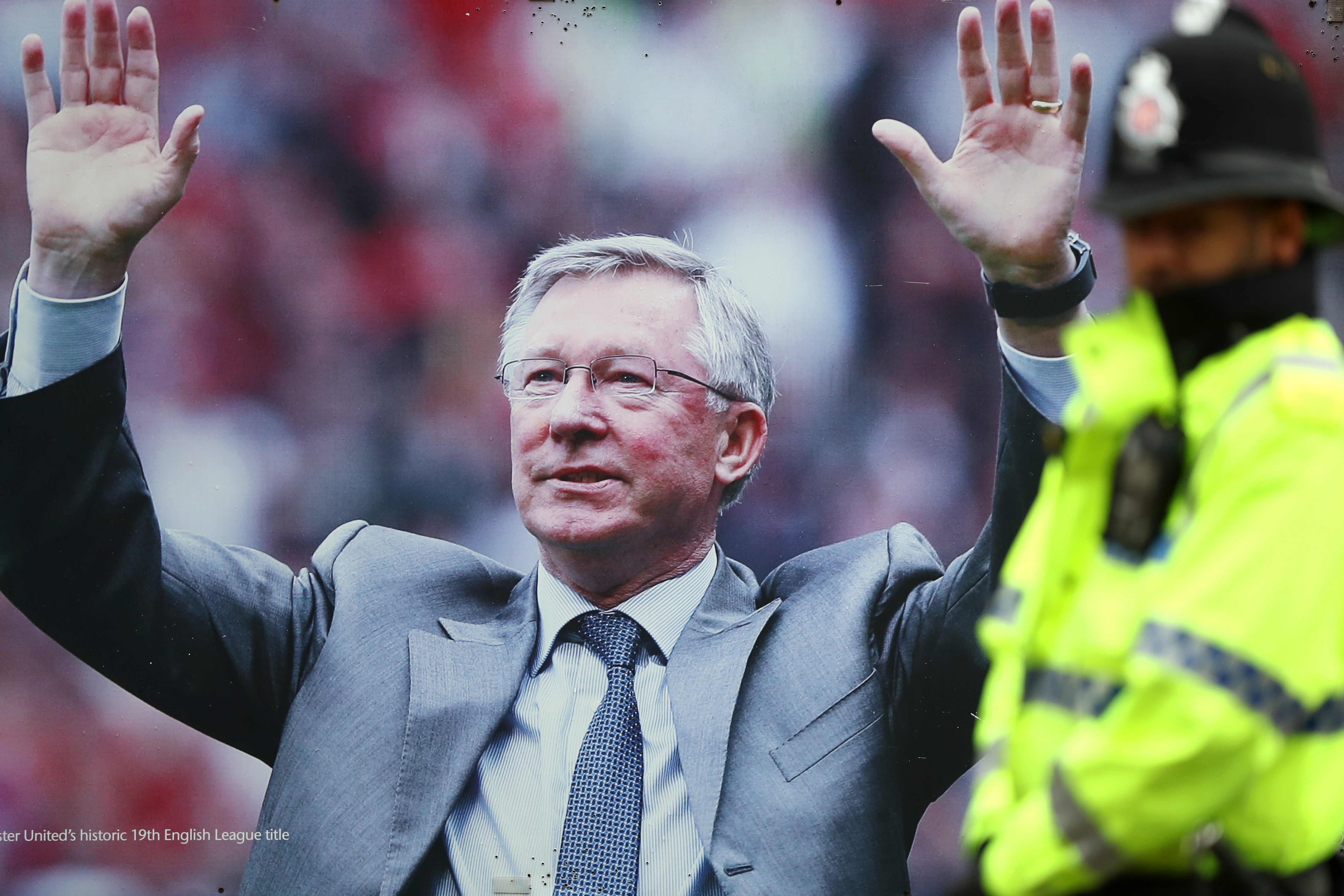 MANCHESTER, ENGLAND - FEBRUARY 11:  A police officer stands in front of the picture of former manager Alex Ferguson prior to the Premier League match between Manchester United and Watford at Old Trafford on February 11, 2017 in Manchester, England.  (Photo by Mark Thompson/Getty Images)