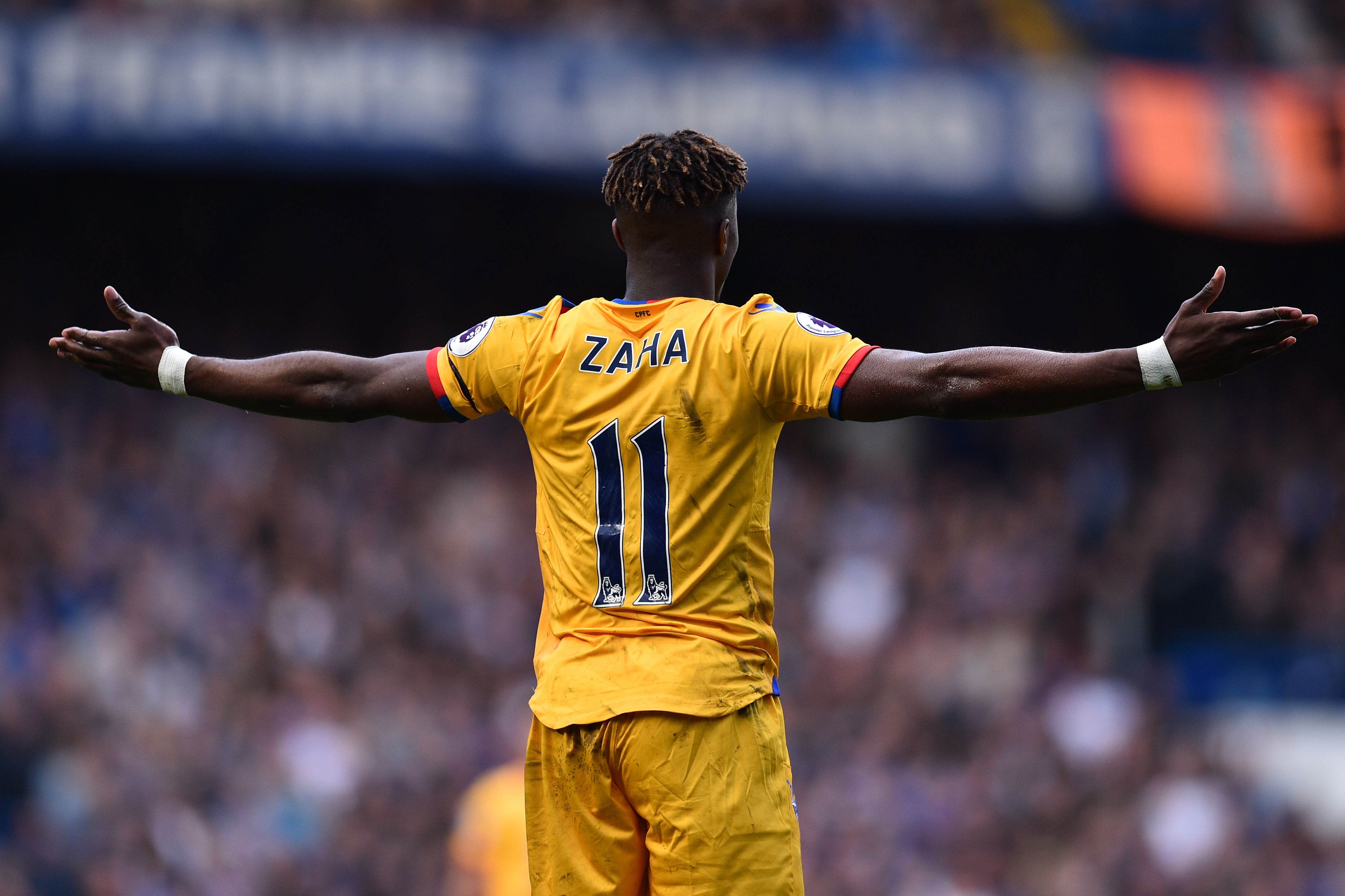 Crystal Palace's Ivorian-born English striker Wilfried Zaha gestures during the English Premier League football match between Chelsea and Crystal Palace at Stamford Bridge in London on April 1, 2017. / AFP PHOTO / Glyn KIRK / RESTRICTED TO EDITORIAL USE. No use with unauthorized audio, video, data, fixture lists, club/league logos or 'live' services. Online in-match use limited to 75 images, no video emulation. No use in betting, games or single club/league/player publications.  /         (Photo credit should read GLYN KIRK/AFP/Getty Images)