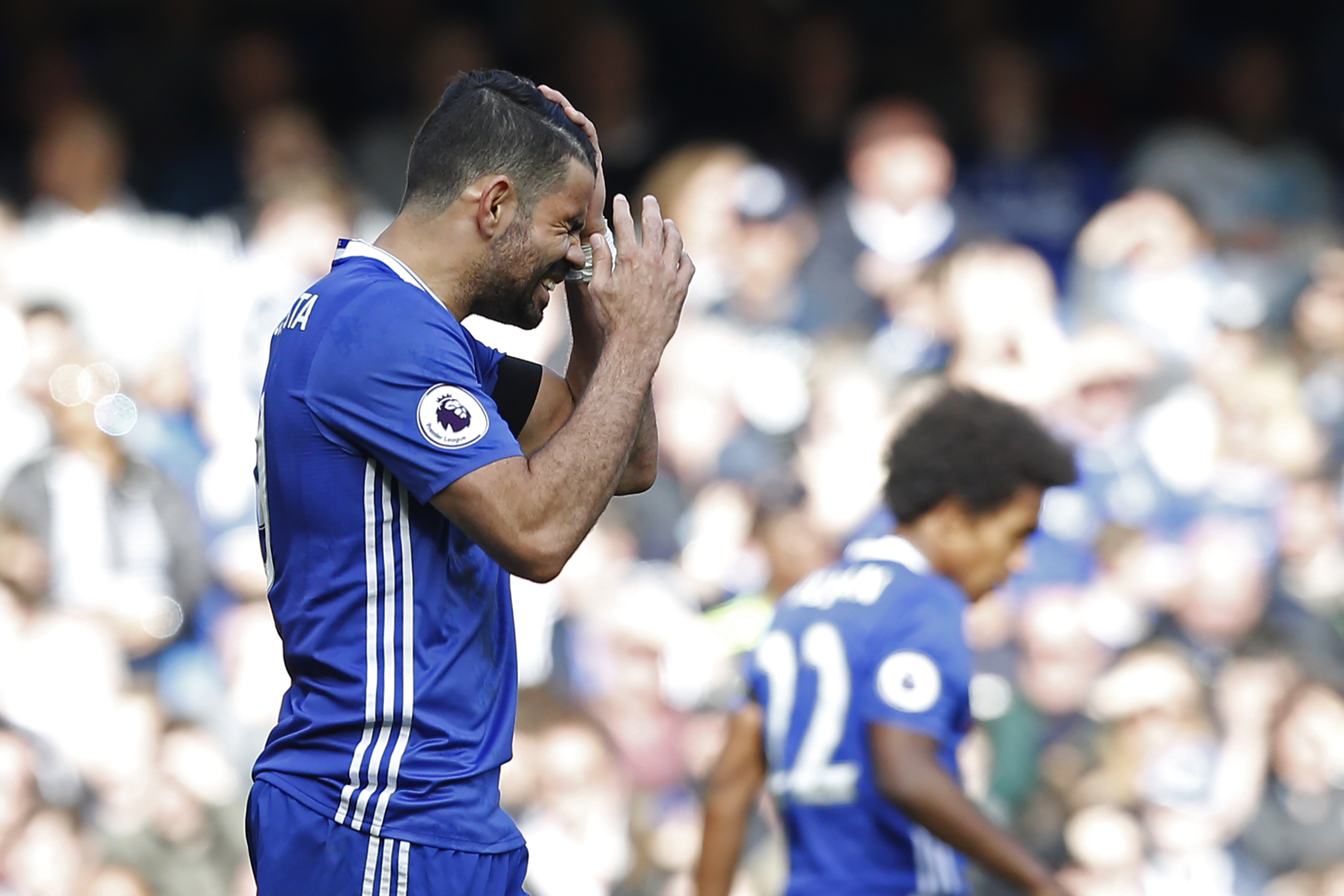 Chelsea's Brazilian-born Spanish striker Diego Costa reacts to missing a chance during the English Premier League football match between Chelsea and Crystal Palace at Stamford Bridge in London on April 1, 2017. / AFP PHOTO / Ian KINGTON / RESTRICTED TO EDITORIAL USE. No use with unauthorized audio, video, data, fixture lists, club/league logos or 'live' services. Online in-match use limited to 75 images, no video emulation. No use in betting, games or single club/league/player publications.  /         (Photo credit should read IAN KINGTON/AFP/Getty Images)