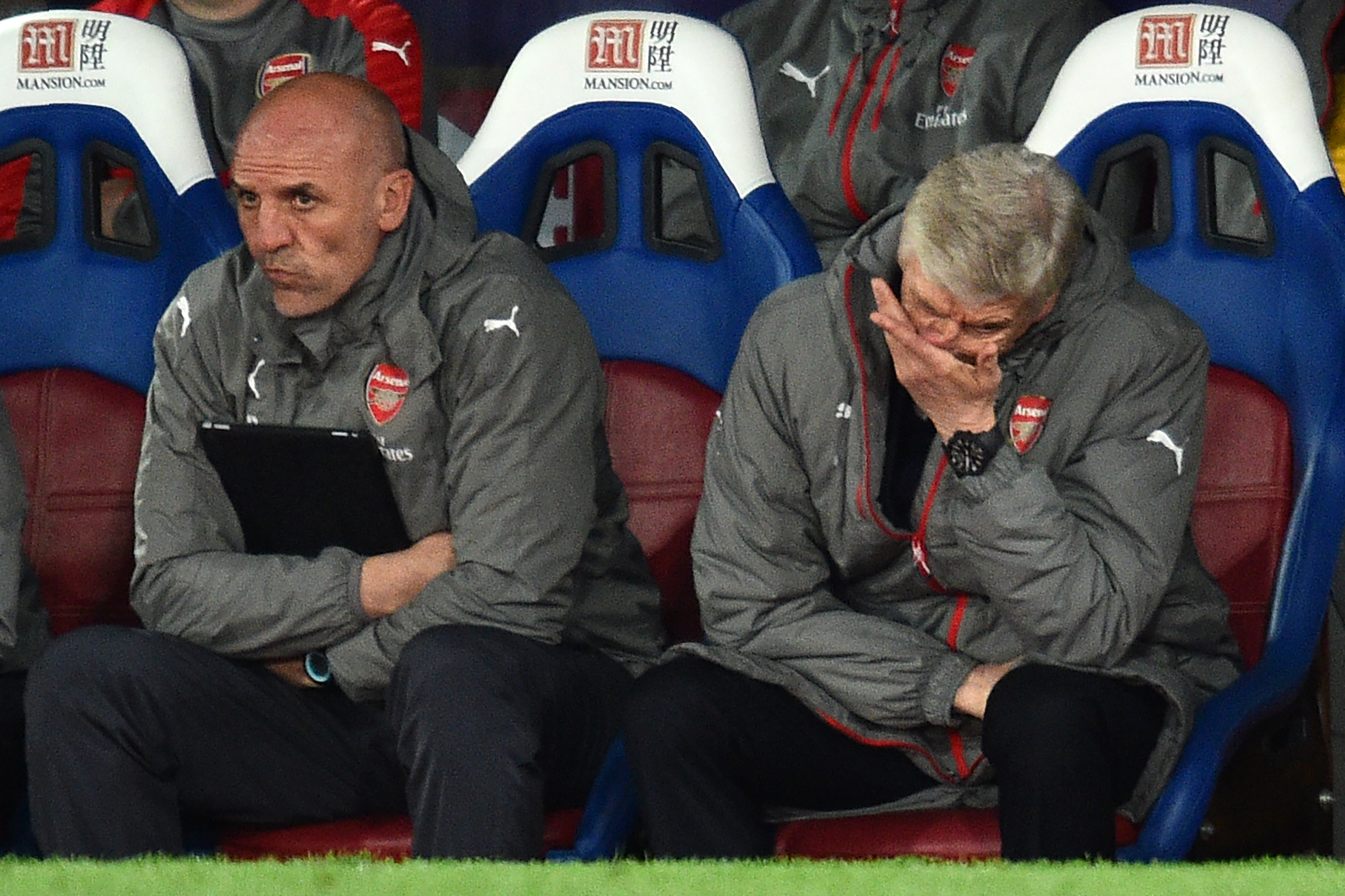 Arsenal's French manager Arsene Wenger (R) and assistant Steve Bould gesture in their seats during the English Premier League football match between Crystal Palace and Arsenal at Selhurst Park in south London on April 10, 2017.
Crystal Palace won the game 3-0. / AFP PHOTO / Glyn KIRK / RESTRICTED TO EDITORIAL USE. No use with unauthorized audio, video, data, fixture lists, club/league logos or 'live' services. Online in-match use limited to 75 images, no video emulation. No use in betting, games or single club/league/player publications.  /         (Photo credit should read GLYN KIRK/AFP/Getty Images)