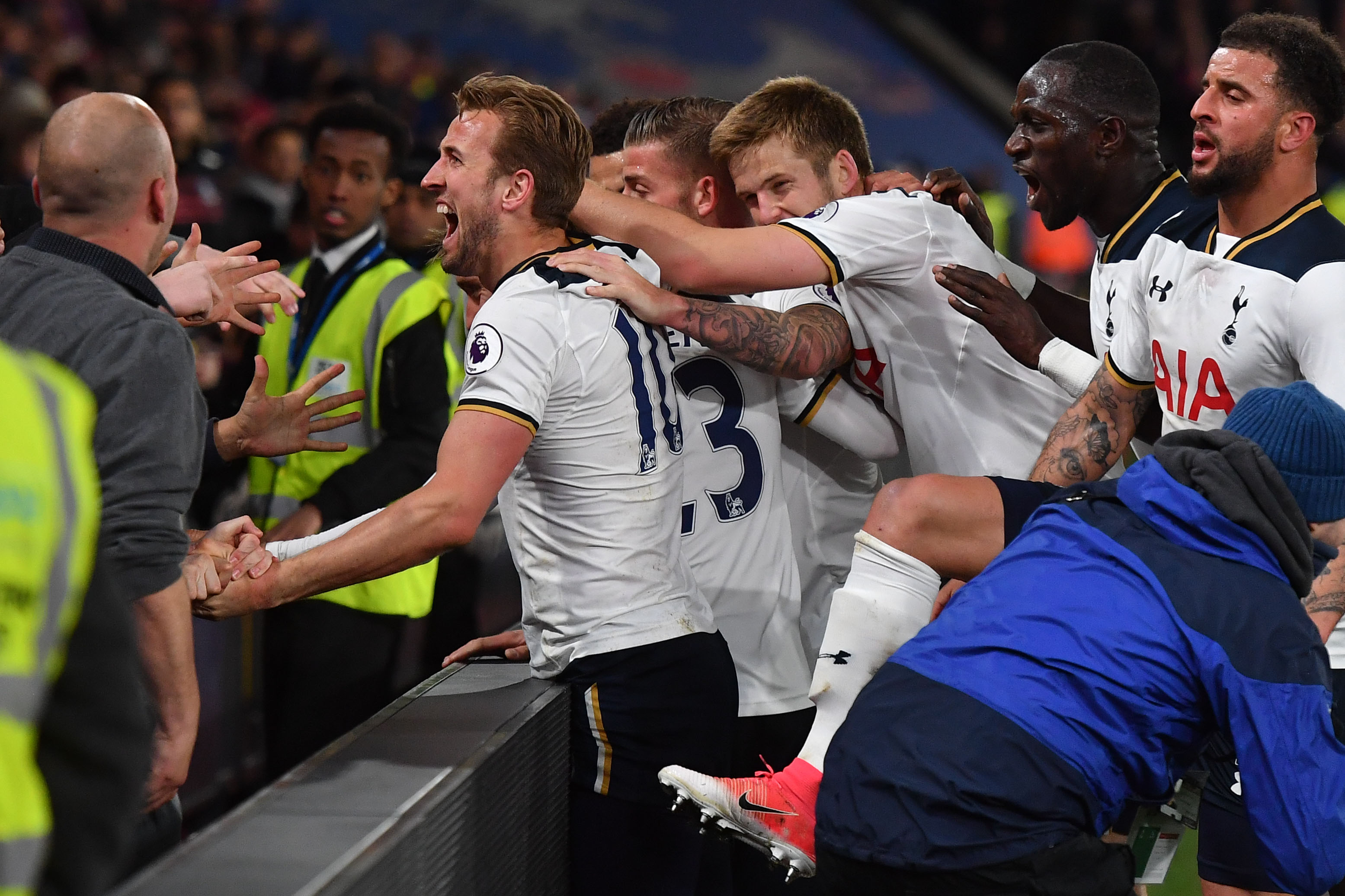 Tottenham Hotspur's Danish midfielder Christian Eriksen (C) celebrates scoring the opening goal with teammates and supporters during the English Premier League football match between Crystal Palace and Tottenham Hotspur at Selhurst Park in south London on April 26, 2017. / AFP PHOTO / Ben STANSALL / RESTRICTED TO EDITORIAL USE. No use with unauthorized audio, video, data, fixture lists, club/league logos or 'live' services. Online in-match use limited to 75 images, no video emulation. No use in betting, games or single club/league/player publications.  /         (Photo credit should read BEN STANSALL/AFP/Getty Images)