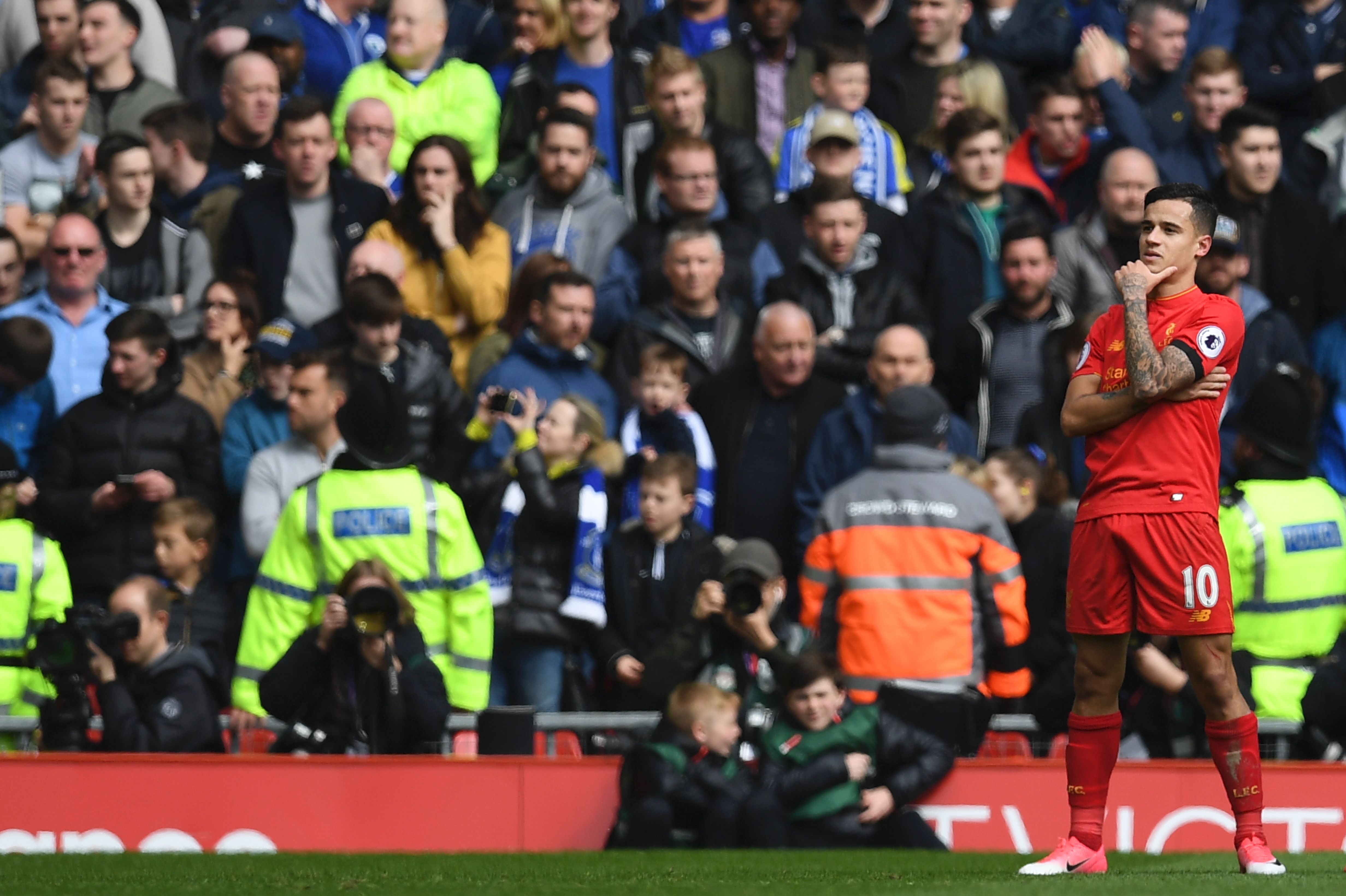 Liverpool's Brazilian midfielder Philippe Coutinho celebrates after scoring their second goal during the English Premier League football match between Liverpool and Everton at Anfield in Liverpool, north west England on April 1, 2017. / AFP PHOTO / Paul ELLIS / RESTRICTED TO EDITORIAL USE. No use with unauthorized audio, video, data, fixture lists, club/league logos or 'live' services. Online in-match use limited to 75 images, no video emulation. No use in betting, games or single club/league/player publications.  /         (Photo credit should read PAUL ELLIS/AFP/Getty Images)