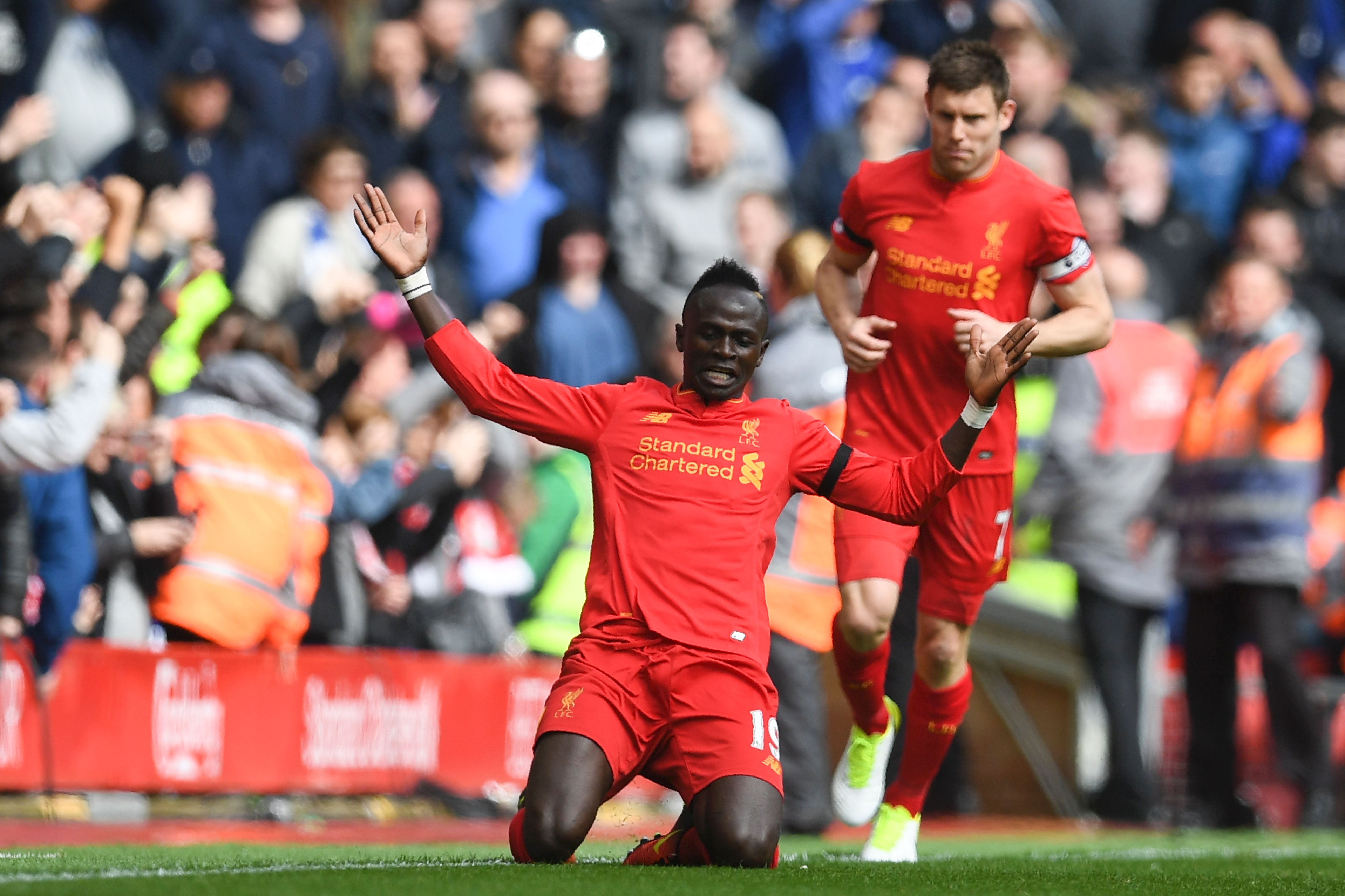 Liverpool's Senegalese midfielder Sadio Mane celebrates after scoring the opening goal of the English Premier League football match between Liverpool and Everton at Anfield in Liverpool, north west England on April 1, 2017. / AFP PHOTO / Paul ELLIS / RESTRICTED TO EDITORIAL USE. No use with unauthorized audio, video, data, fixture lists, club/league logos or 'live' services. Online in-match use limited to 75 images, no video emulation. No use in betting, games or single club/league/player publications.  /         (Photo credit should read PAUL ELLIS/AFP/Getty Images)