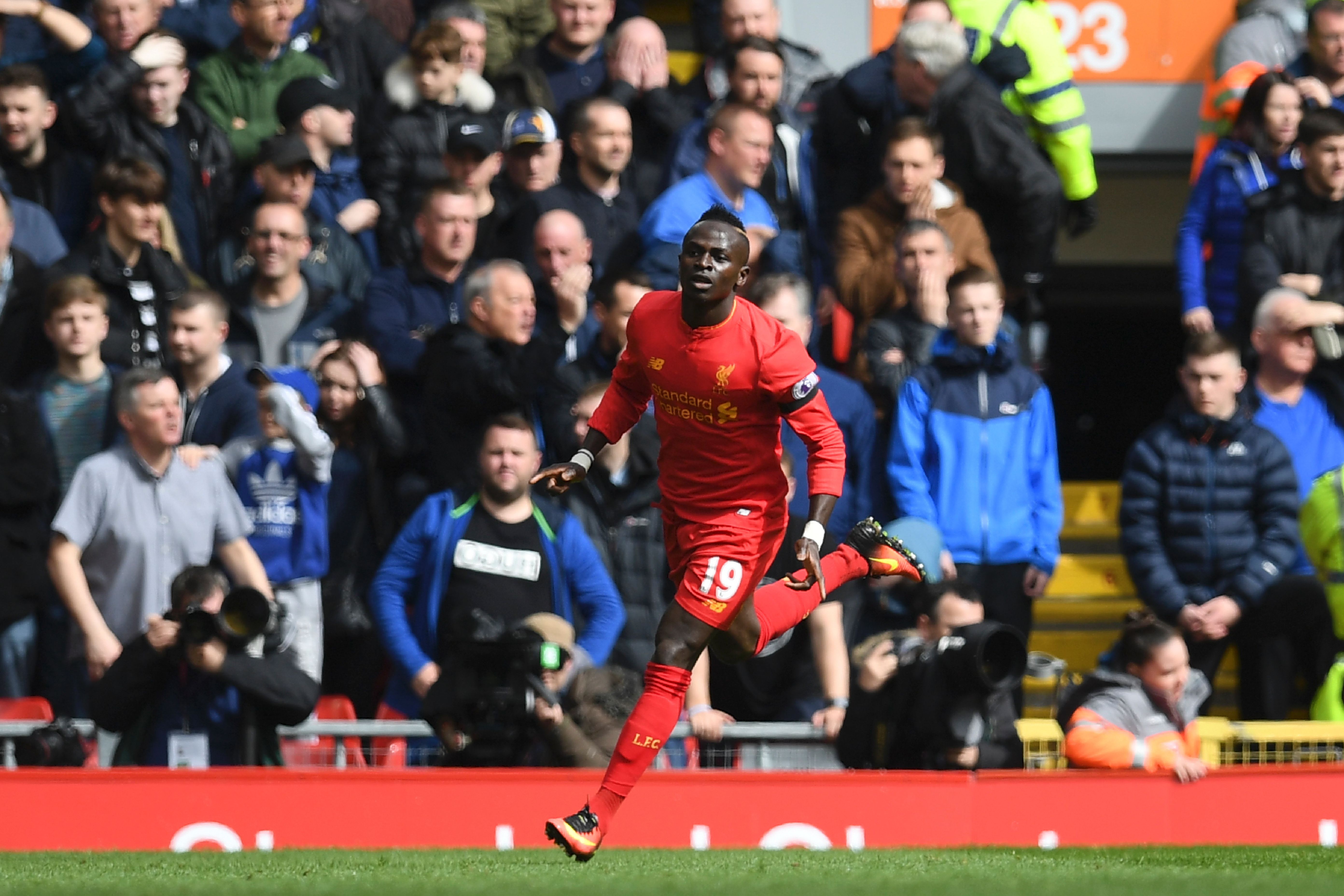 Liverpool's Senegalese midfielder Sadio Mane celebrates after scoring the opening goal of the English Premier League football match between Liverpool and Everton at Anfield in Liverpool, north west England on April 1, 2017. / AFP PHOTO / Paul ELLIS / RESTRICTED TO EDITORIAL USE. No use with unauthorized audio, video, data, fixture lists, club/league logos or 'live' services. Online in-match use limited to 75 images, no video emulation. No use in betting, games or single club/league/player publications.  /         (Photo credit should read PAUL ELLIS/AFP/Getty Images)