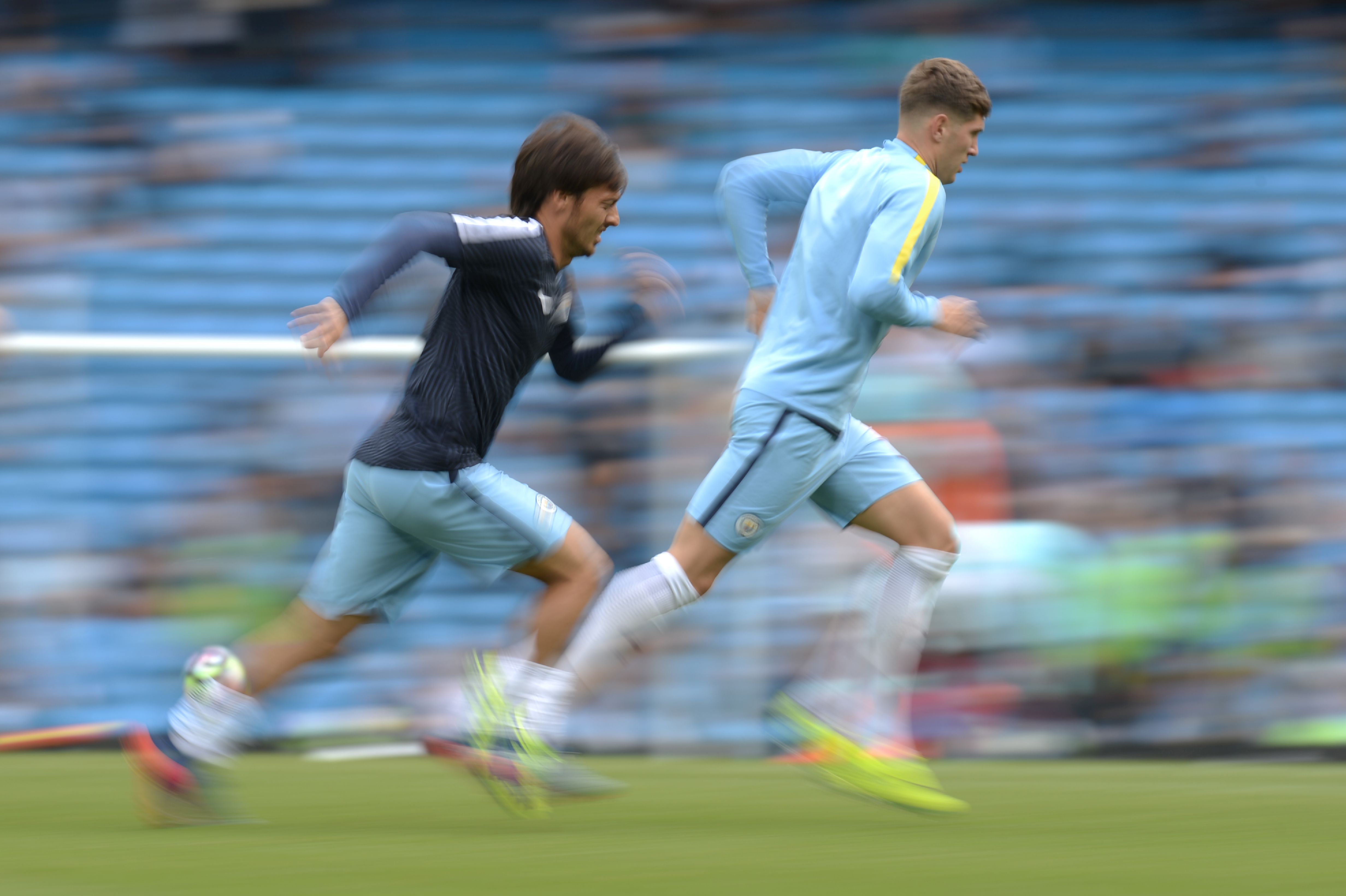 Manchester City's Spanish midfielder David Silva (L) and Manchester City's English defender John Stones warm up before the English Premier League football match between Manchester City and West Ham United at the Etihad Stadium in Manchester, north west England, on August 28, 2016. / AFP / OLI SCARFF / RESTRICTED TO EDITORIAL USE. No use with unauthorized audio, video, data, fixture lists, club/league logos or 'live' services. Online in-match use limited to 75 images, no video emulation. No use in betting, games or single club/league/player publications.  /         (Photo credit should read OLI SCARFF/AFP/Getty Images)
