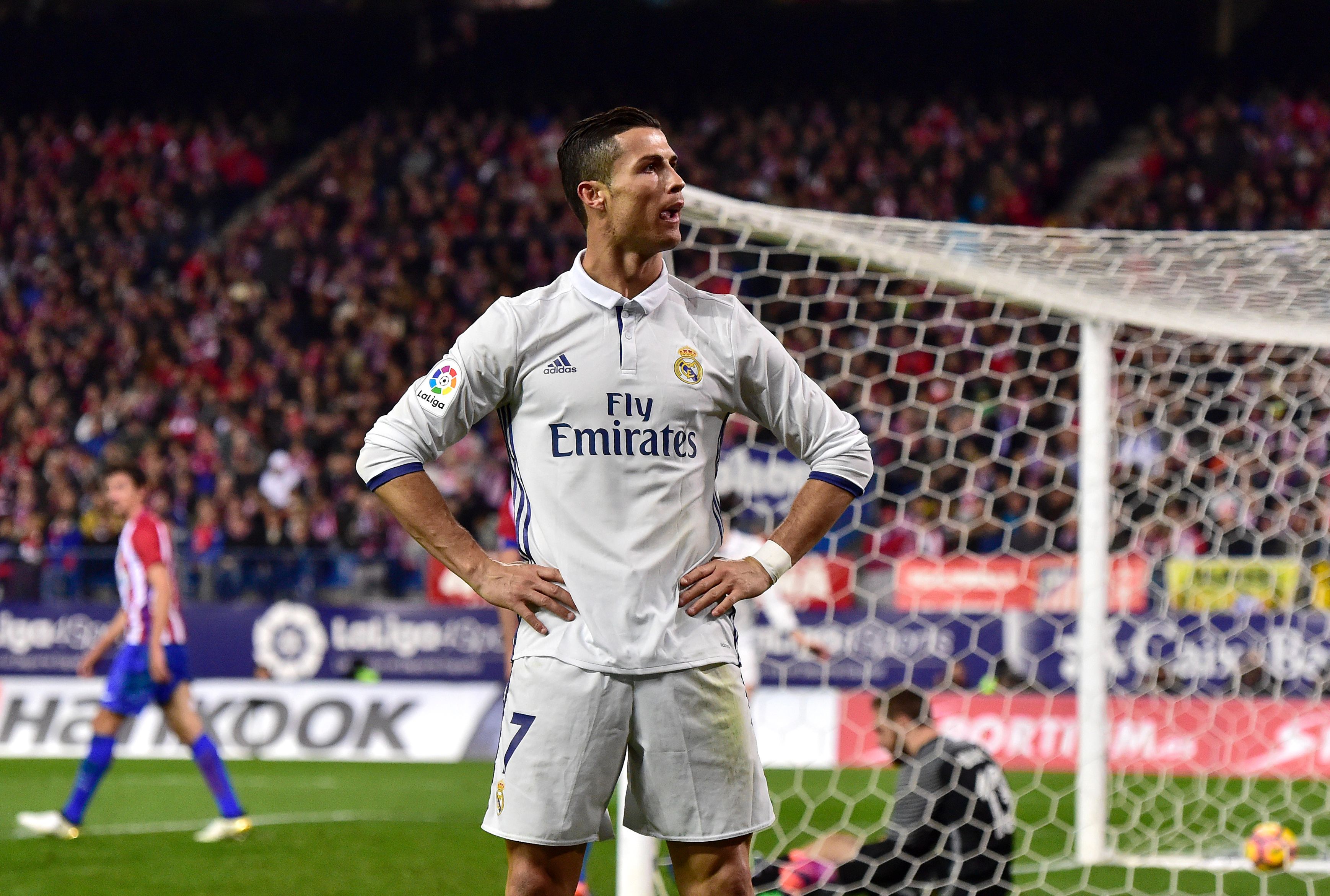 Real Madrid's Portuguese forward Cristiano Ronaldo celebrates after scoring his third goal during the Spanish league football match Club Atletico de Madrid vs Real Madrid CF at the Vicente Calderon stadium in Madrid, on November 19, 2016. Real Madrid won 3-0. / AFP / GERARD JULIEN        (Photo credit should read GERARD JULIEN/AFP/Getty Images)
