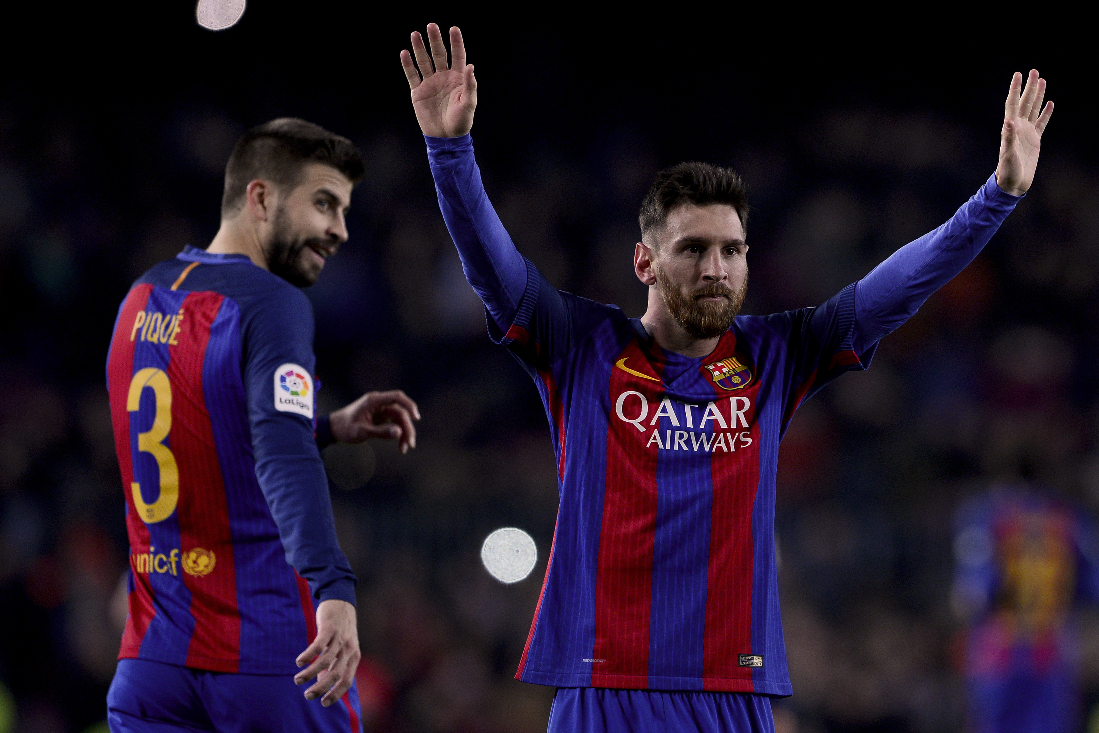 Barcelona's Argentinian forward Lionel Messi (R) celebrates his goal beside Barcelona's defender Gerard Pique during the Spanish league football match FC Barcelona vs RCD Espanyol at the Camp Nou stadium in Barcelona on December 18, 2016. / AFP / JOSEP LAGO        (Photo credit should read JOSEP LAGO/AFP/Getty Images)