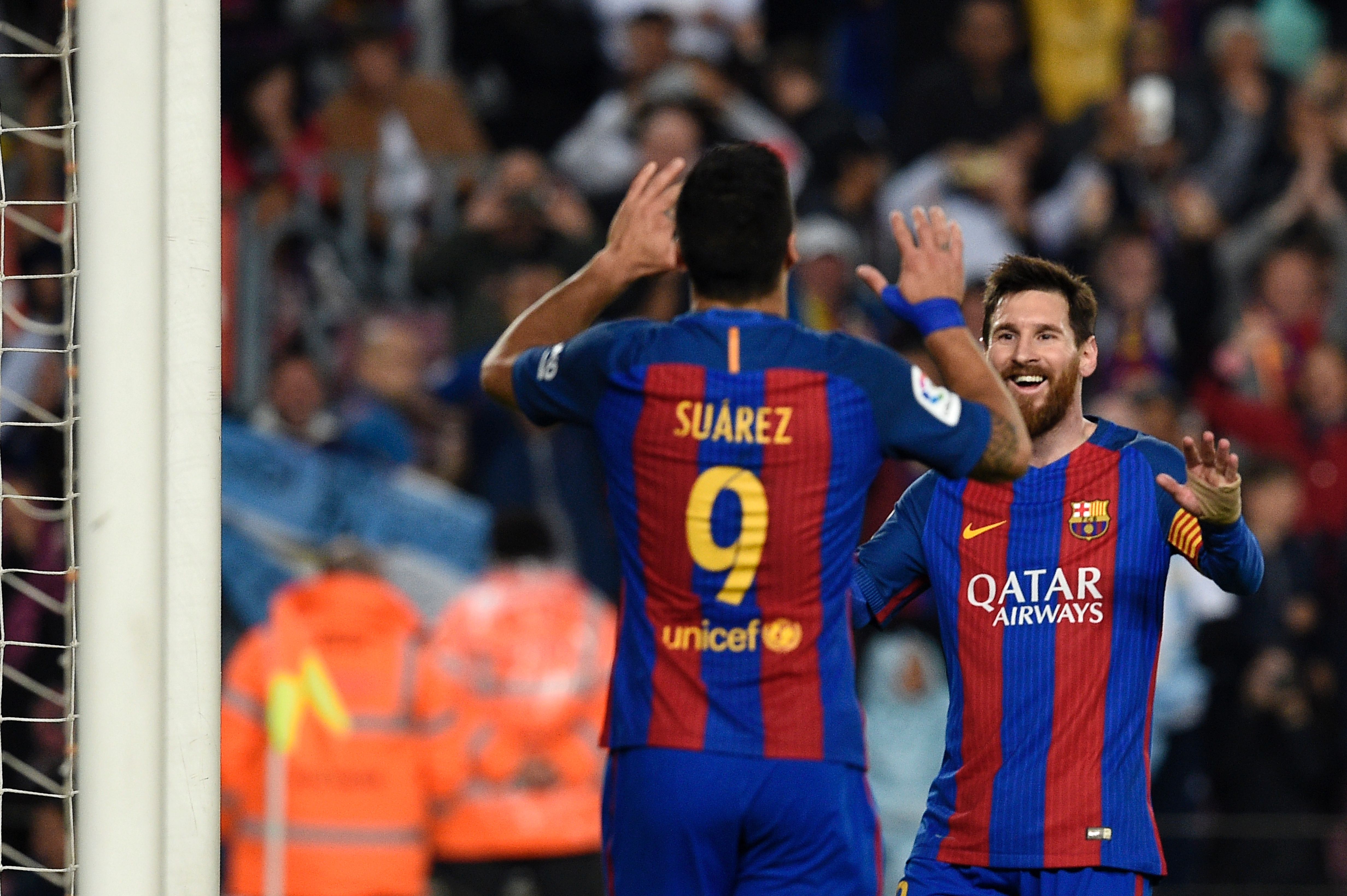 Barcelona's Argentinian forward Lionel Messi (R) celebrates with Barcelona's Uruguayan forward Luis Suarez after scoring a goal during the Spanish league football match FC Barcelona vs Real Sociedad at the Camp Nou stadium in Barcelona on April 15, 2017. / AFP PHOTO / LLUIS GENE        (Photo credit should read LLUIS GENE/AFP/Getty Images)