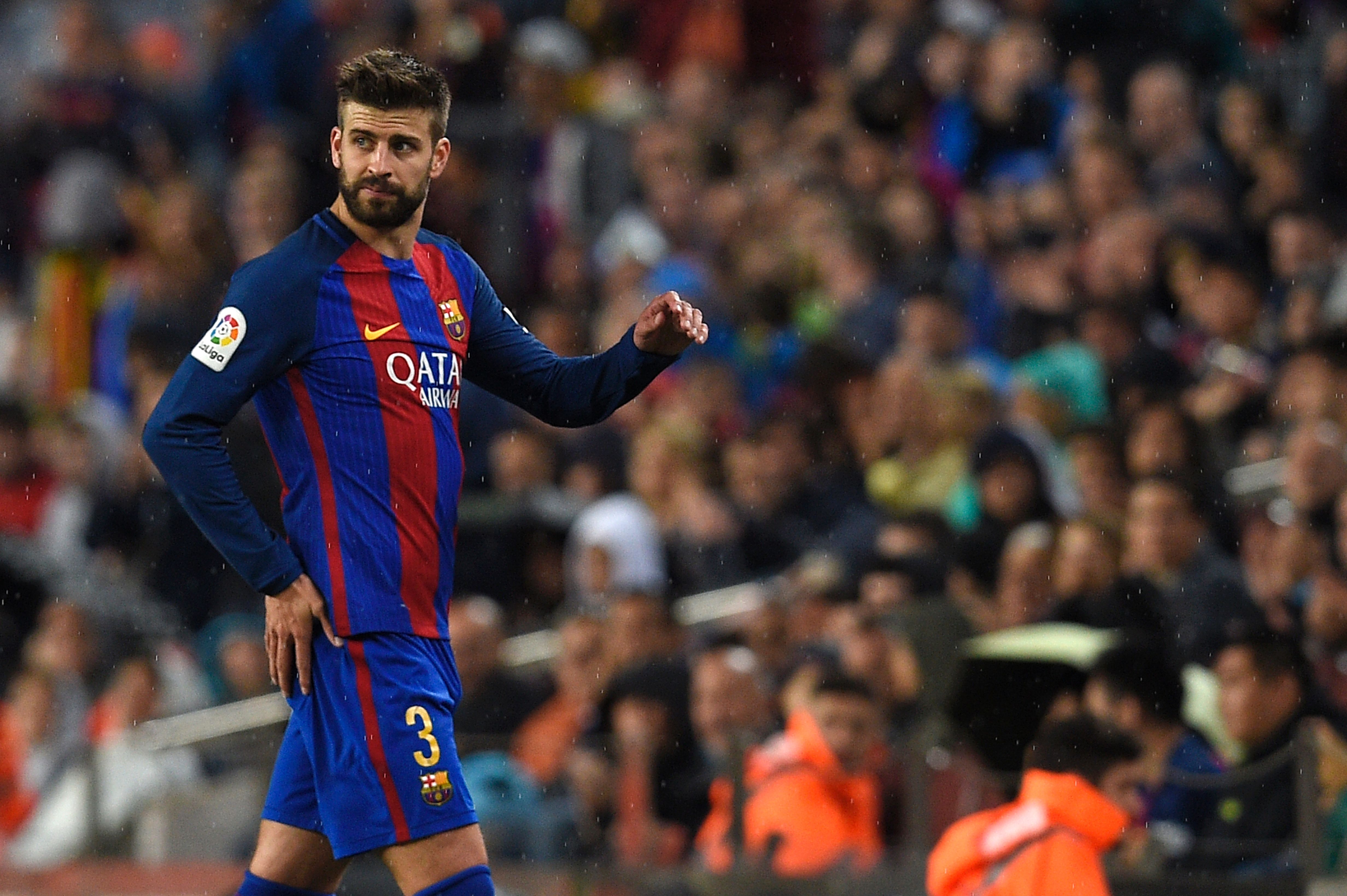 Barcelona's defender Gerard Pique leaves the pitch during the Spanish league football match FC Barcelona vs Sevilla FC at the Camp Nou stadium in Barcelona on April 5, 2017. / AFP PHOTO / LLUIS GENE        (Photo credit should read LLUIS GENE/AFP/Getty Images)