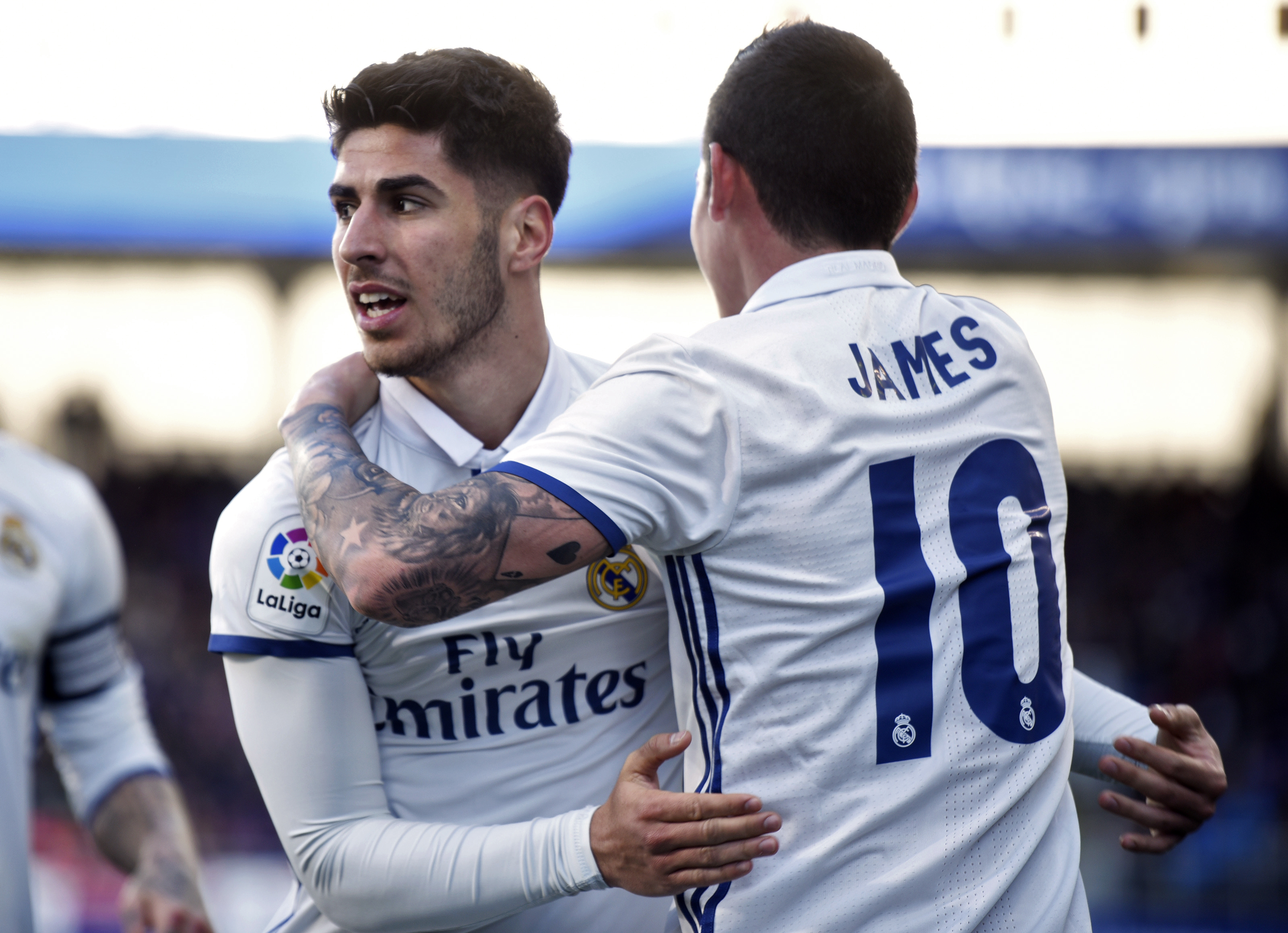 Real Madrid's midfielder Marco Asensio Willemsen (L) celebrates with Real Madrid's Colombian midfielder James Rodriguez after scoring his team's fourth goal during the Spanish league football match SD Eibar vs Real Madrid CF at the Ipurua stadium in Eibar on March 4, 2017. / AFP PHOTO / ANDER GILLENEA        (Photo credit should read ANDER GILLENEA/AFP/Getty Images)