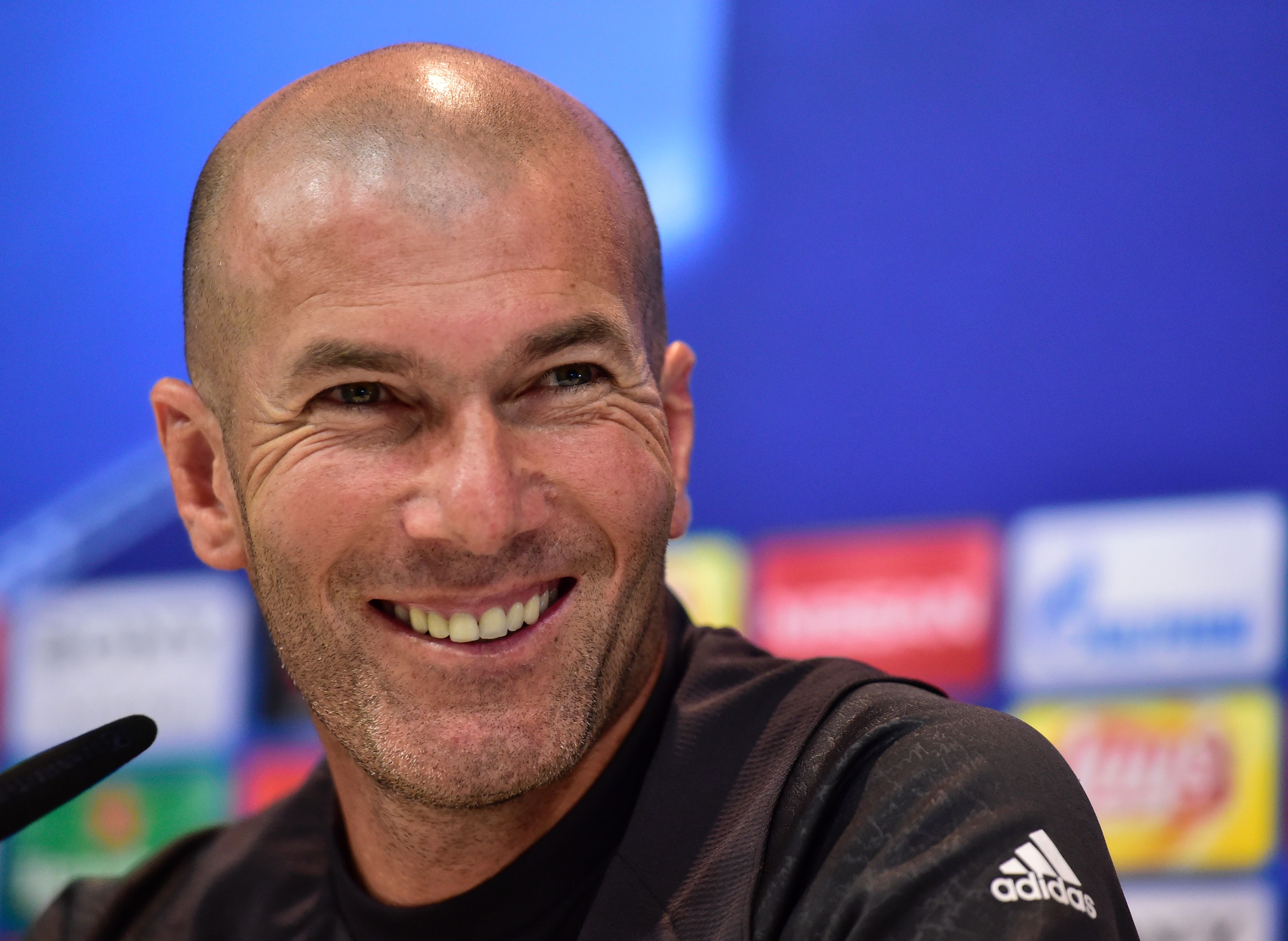 Real Madrid's French coach Zinedine Zidane smiles during a press conference at Valdebebas Sport City  in Madrid on April 17, 2017, on the eve of the UEFA Champions League quarter-final second leg football match Real Madrid vs FC Bayern Munich . / AFP PHOTO / GERARD JULIEN        (Photo credit should read GERARD JULIEN/AFP/Getty Images)