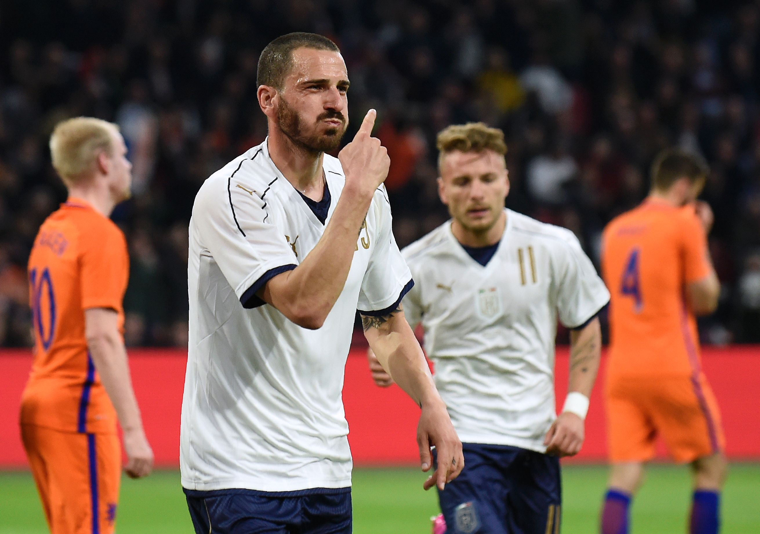 Italy's Leonardo Bonucci celebrates after scoring a goal during the friendly football match between The Netherlands and Italy at the Arena Stadium, on March 28, 2017 in Amsterdam. / AFP PHOTO / JOHN THYS        (Photo credit should read JOHN THYS/AFP/Getty Images)