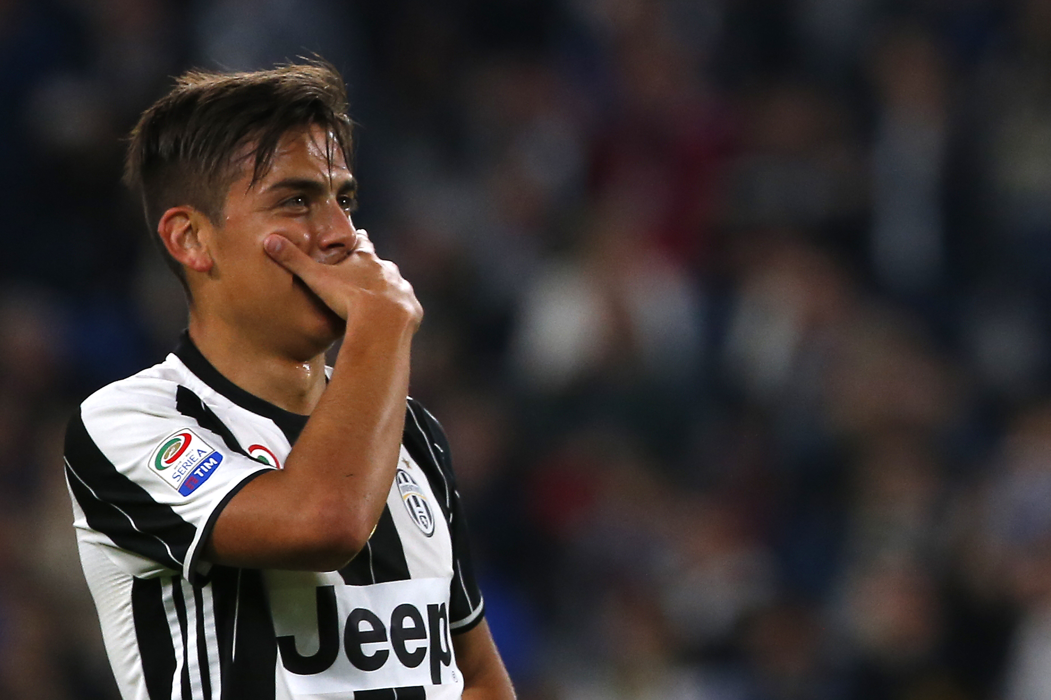 Juventus' forward Paulo Dybala from Argentina celebrates after scoring during the Italian Serie A football match Juventus Vs Genoa on April 23, 2017 at the 'Juventus Stadium' in Turin.  / AFP PHOTO / Marco BERTORELLO        (Photo credit should read MARCO BERTORELLO/AFP/Getty Images)