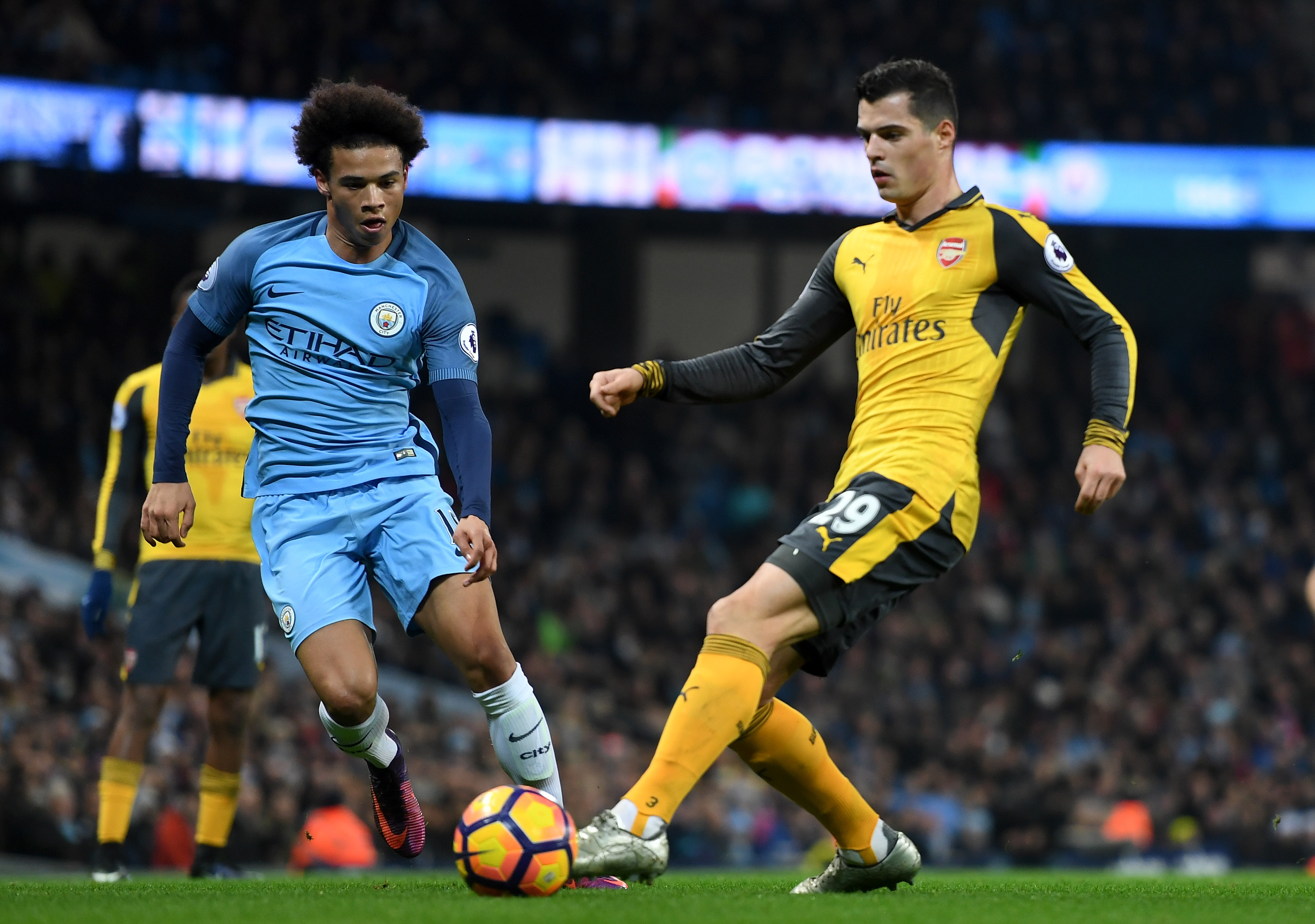 MANCHESTER, ENGLAND - DECEMBER 18: Granit Xhaka of Arsenal (R) is put under pressure from Leroy Sane of Manchester City (L) during the Premier League match between Manchester City and Arsenal at the Etihad Stadium on December 18, 2016 in Manchester, England.  (Photo by Michael Regan/Getty Images)