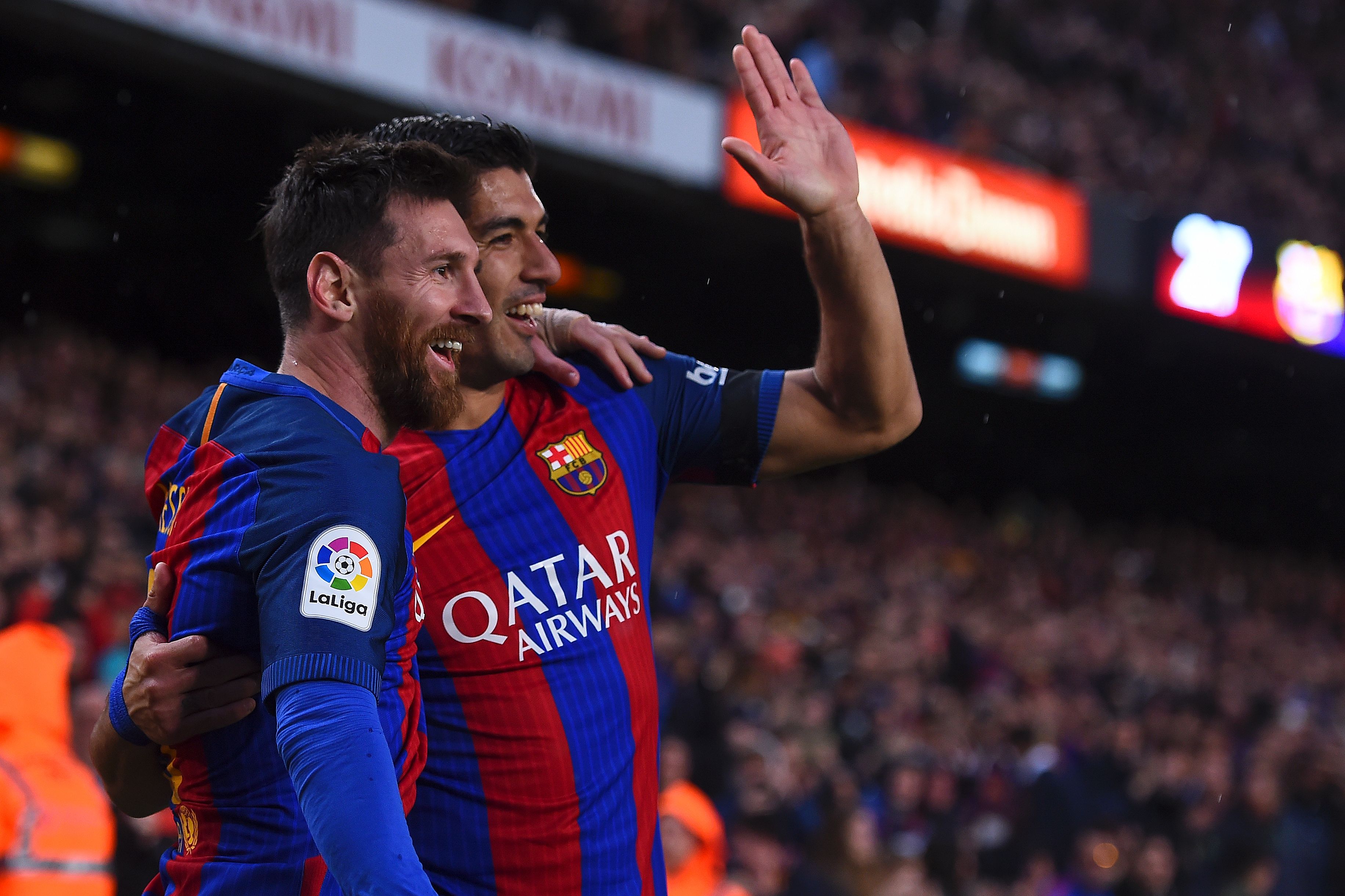 TOPSHOT - Barcelona's Argentinian forward Lionel Messi (L) is congratulated by Barcelona's Uruguayan forward Luis Suarez after scoring during the Spanish league football match FC Barcelona vs Sevilla FC at the Camp Nou stadium in Barcelona on April 5, 2017. / AFP PHOTO / Josep LAGO        (Photo credit should read JOSEP LAGO/AFP/Getty Images)