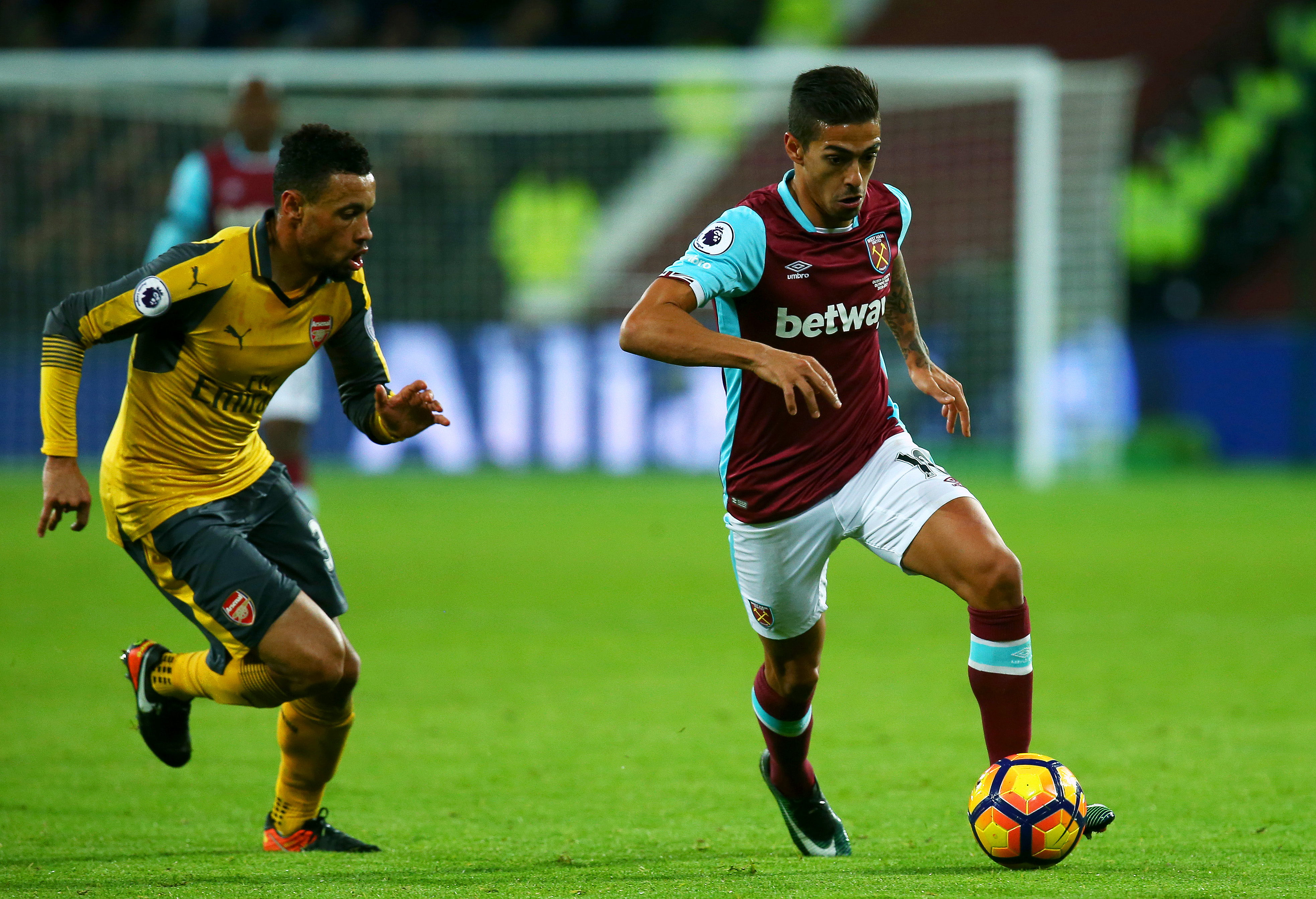 LONDON, ENGLAND - DECEMBER 03:  Manuel Lanzini of West Ham runs with the ball under pressure from Francis Coquelin of Arsenal during the Premier League match between West Ham United and Arsenal at London Stadium on December 3, 2016 in London, England.  (Photo by Charlie Crowhurst/Getty Images)