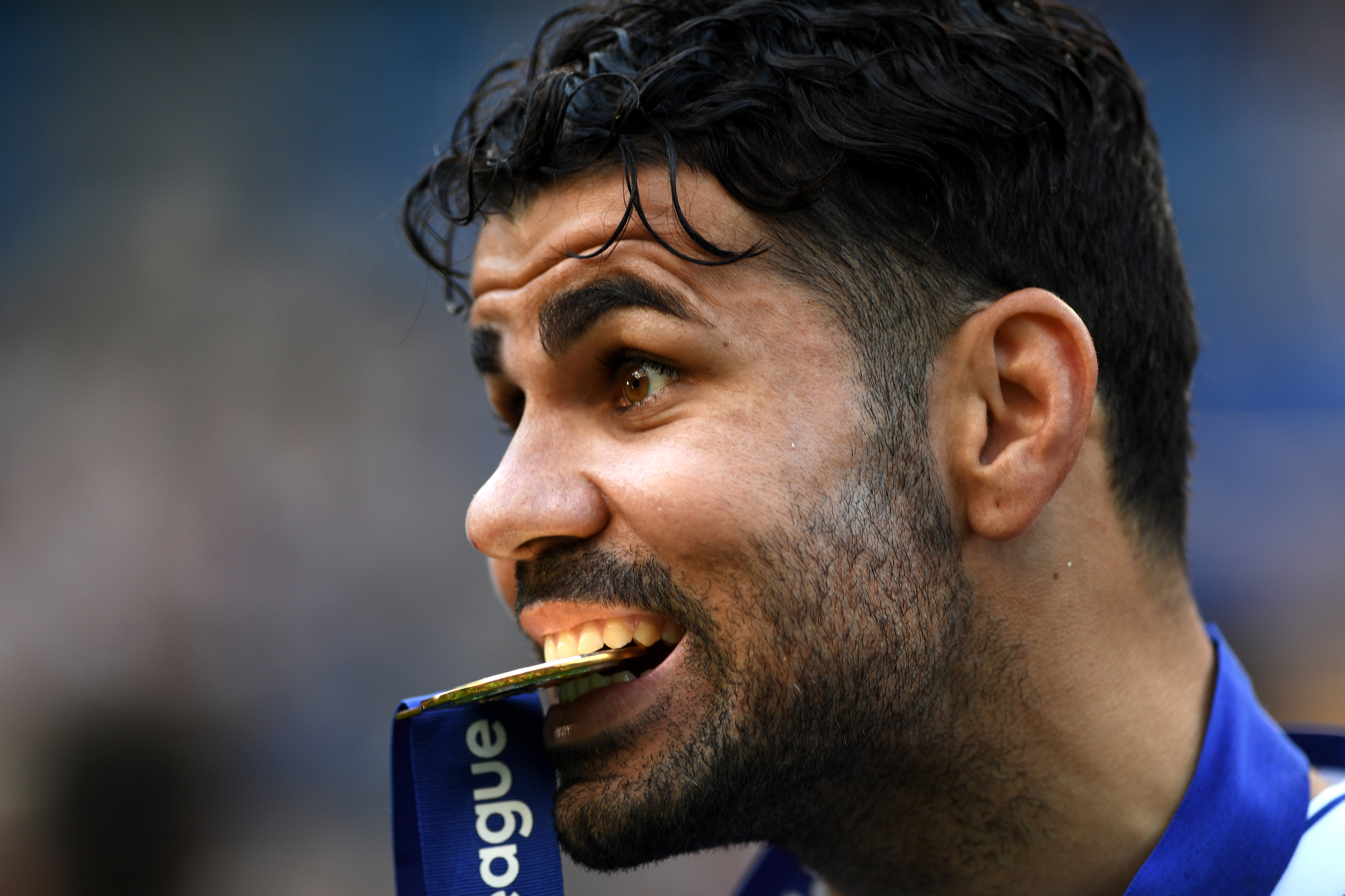 LONDON, ENGLAND - MAY 21:  Diego Costa of Chelsea bites the premier league medal following the Premier League match between Chelsea and Sunderland at Stamford Bridge on May 21, 2017 in London, England.  (Photo by Shaun Botterill/Getty Images)