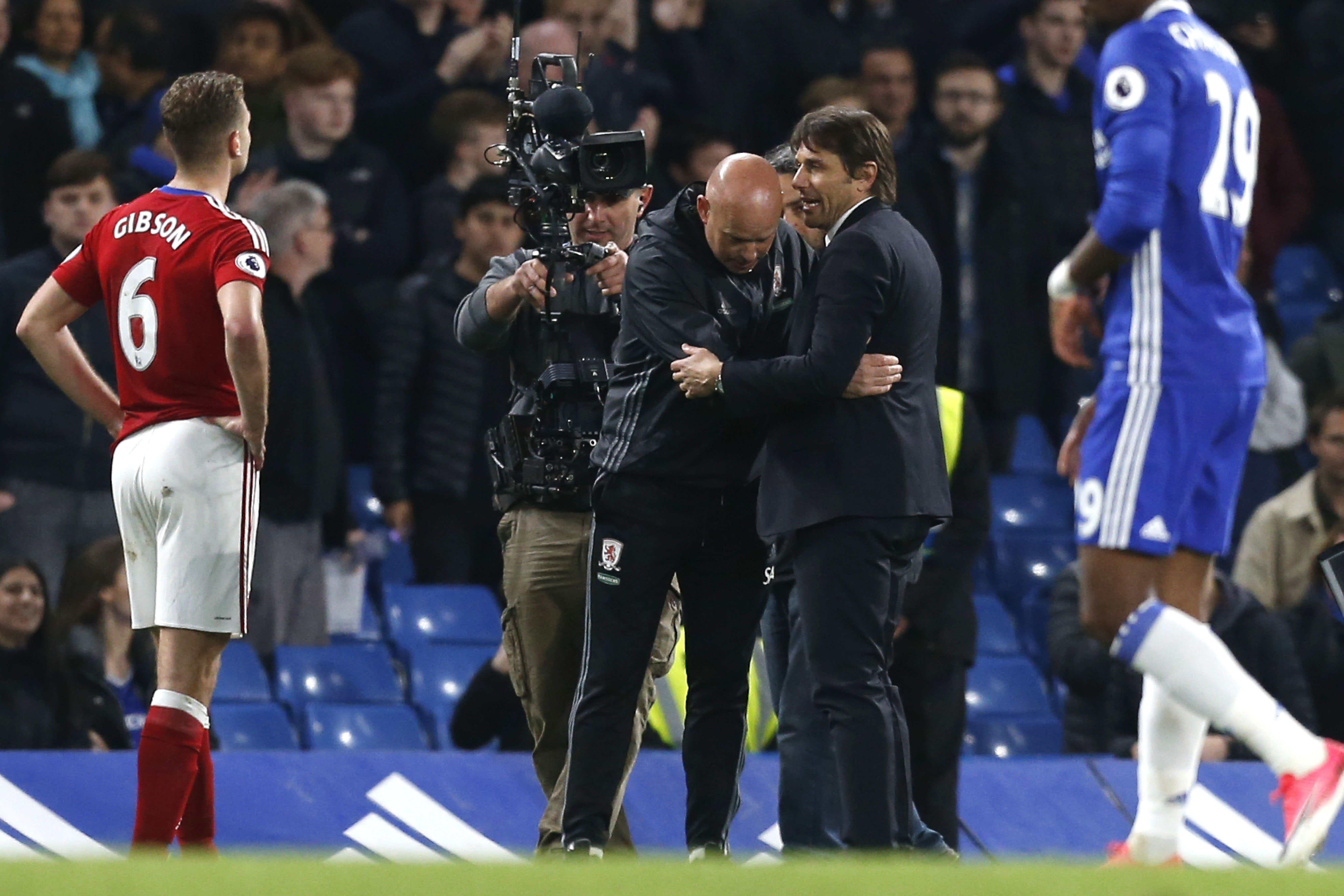 Chelsea's Italian head coach Antonio Conte (R) speaks with Middlesbrough's English head coach Steve Agnew after the end of the English Premier League football match between Chelsea and Middlesbrough at Stamford Bridge in London on May 8, 2017. / AFP PHOTO / Ian KINGTON / RESTRICTED TO EDITORIAL USE. No use with unauthorized audio, video, data, fixture lists, club/league logos or 'live' services. Online in-match use limited to 75 images, no video emulation. No use in betting, games or single club/league/player publications.  /         (Photo credit should read IAN KINGTON/AFP/Getty Images)